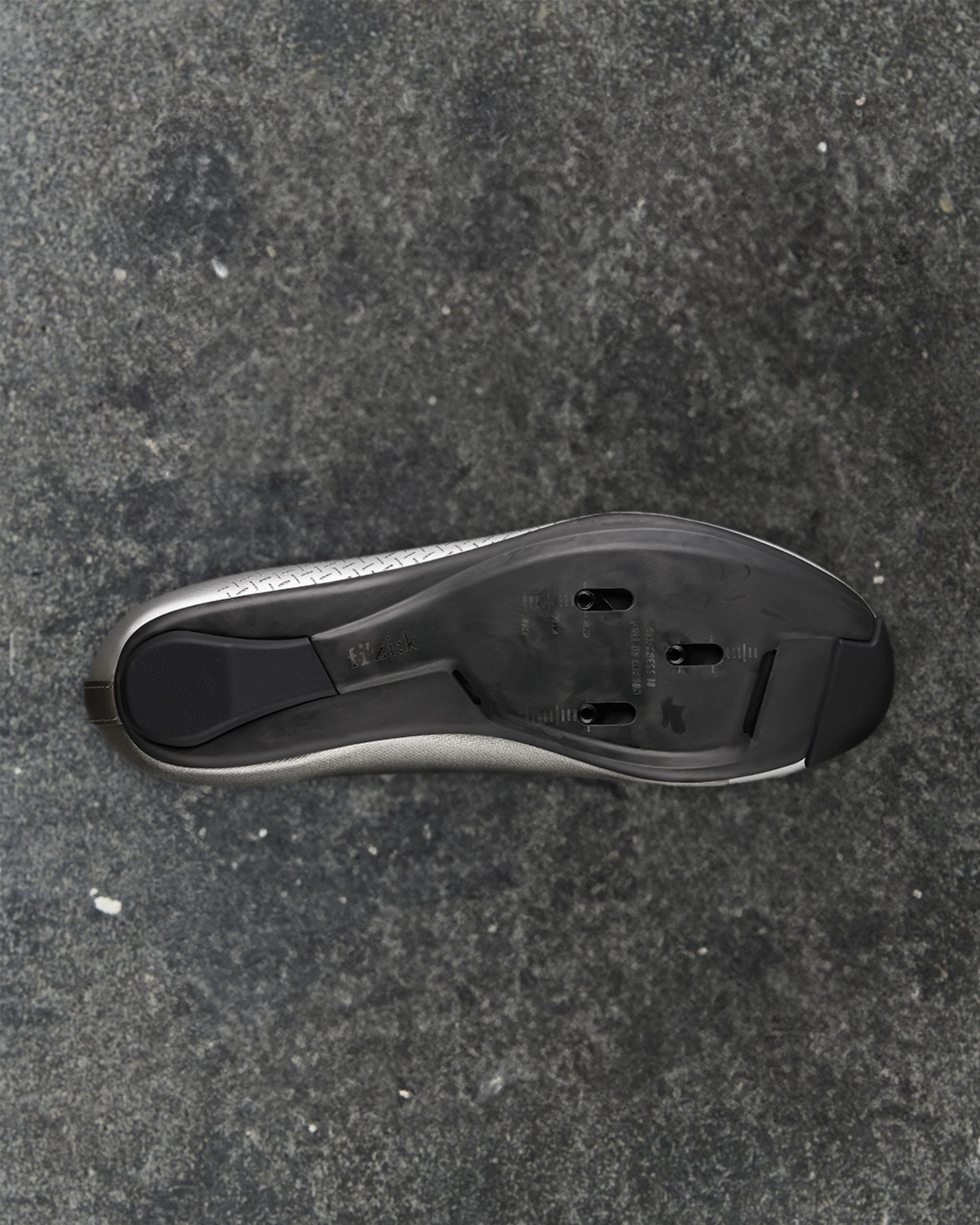 Silver Fizik Mechanism road shoe, sole view showing cleat mounting system