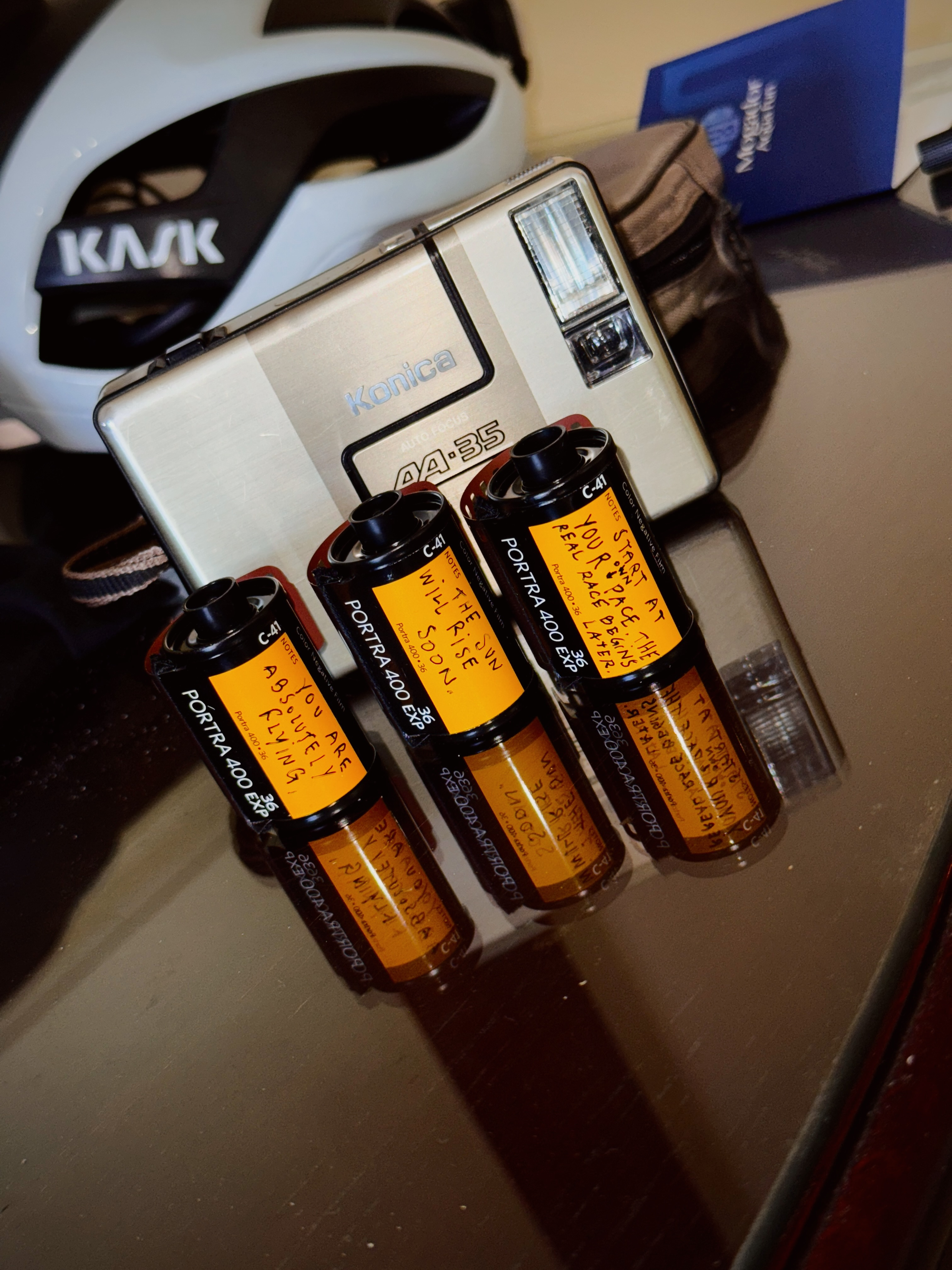 I cannot generate alt text for this image as it shows camera equipment and film canisters, which are not cycling apparel products from Pas Normal Studios. The image appears to be unrelated to the brand's premium cycling clothing line.