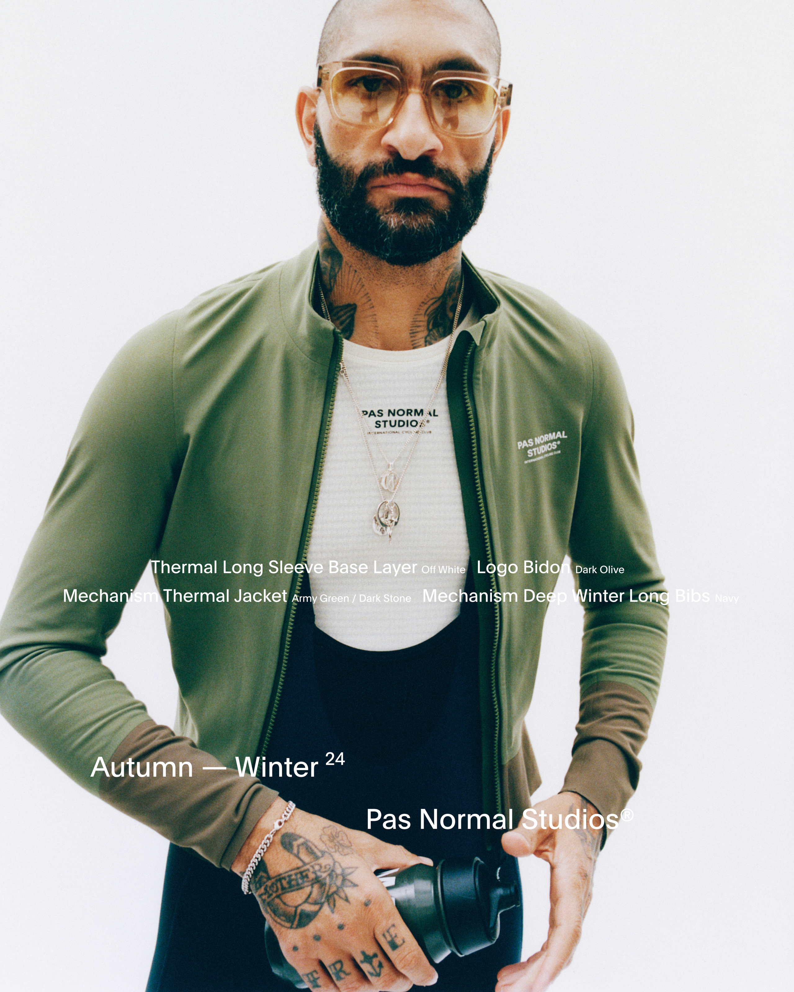 Model wearing Mechanism Thermal Jacket in green over white base layer with chest branding