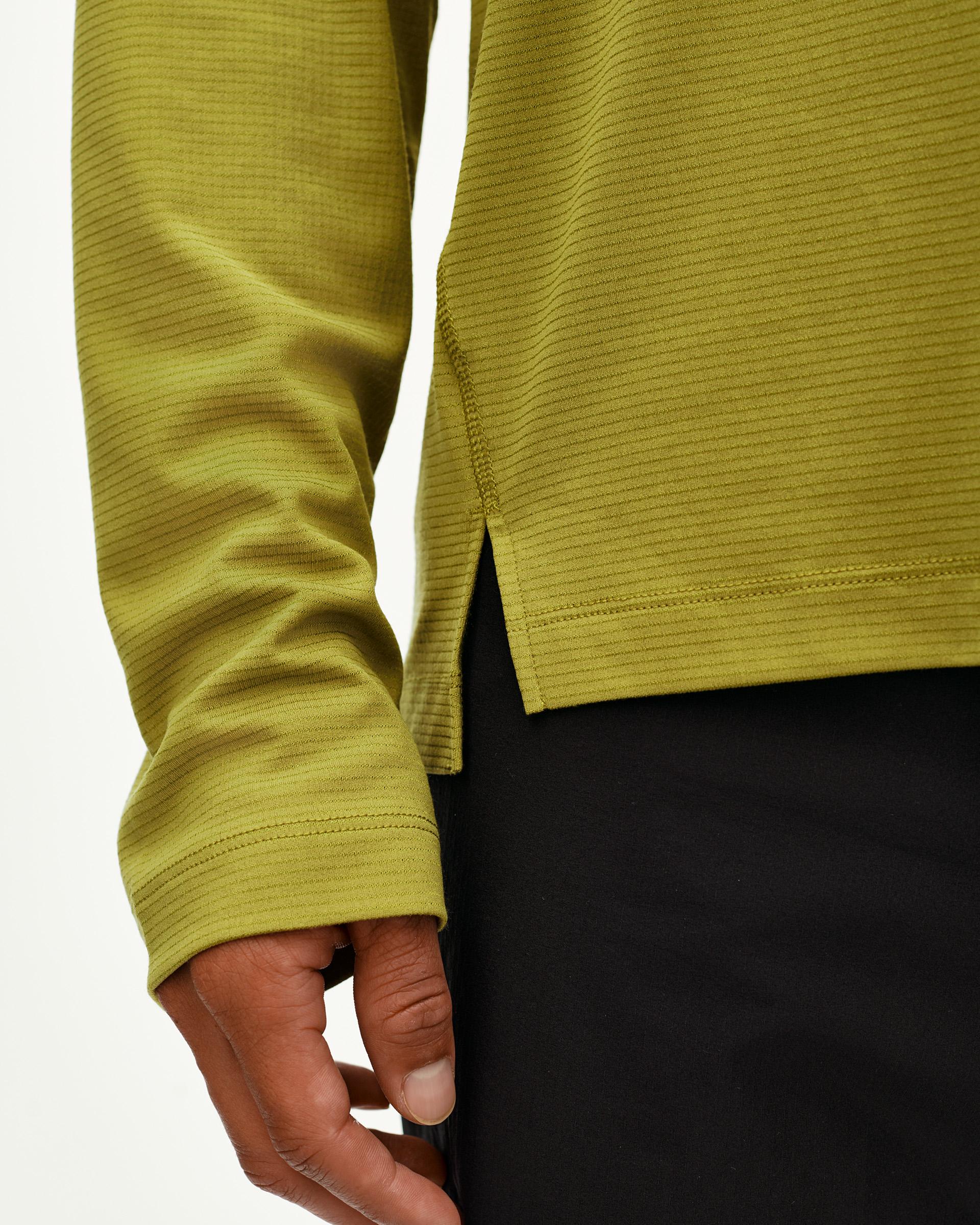 Dark Lime Balance long sleeve T-shirt, side detail on model showing ribbed texture and hem vent