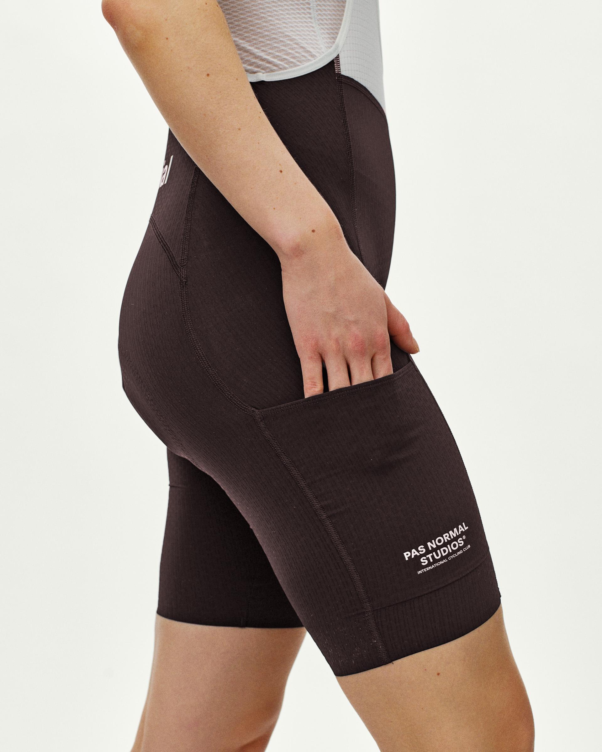 Dark Purple Essential Light Cargo cycling bibs on model showing side cargo pocket with white logo