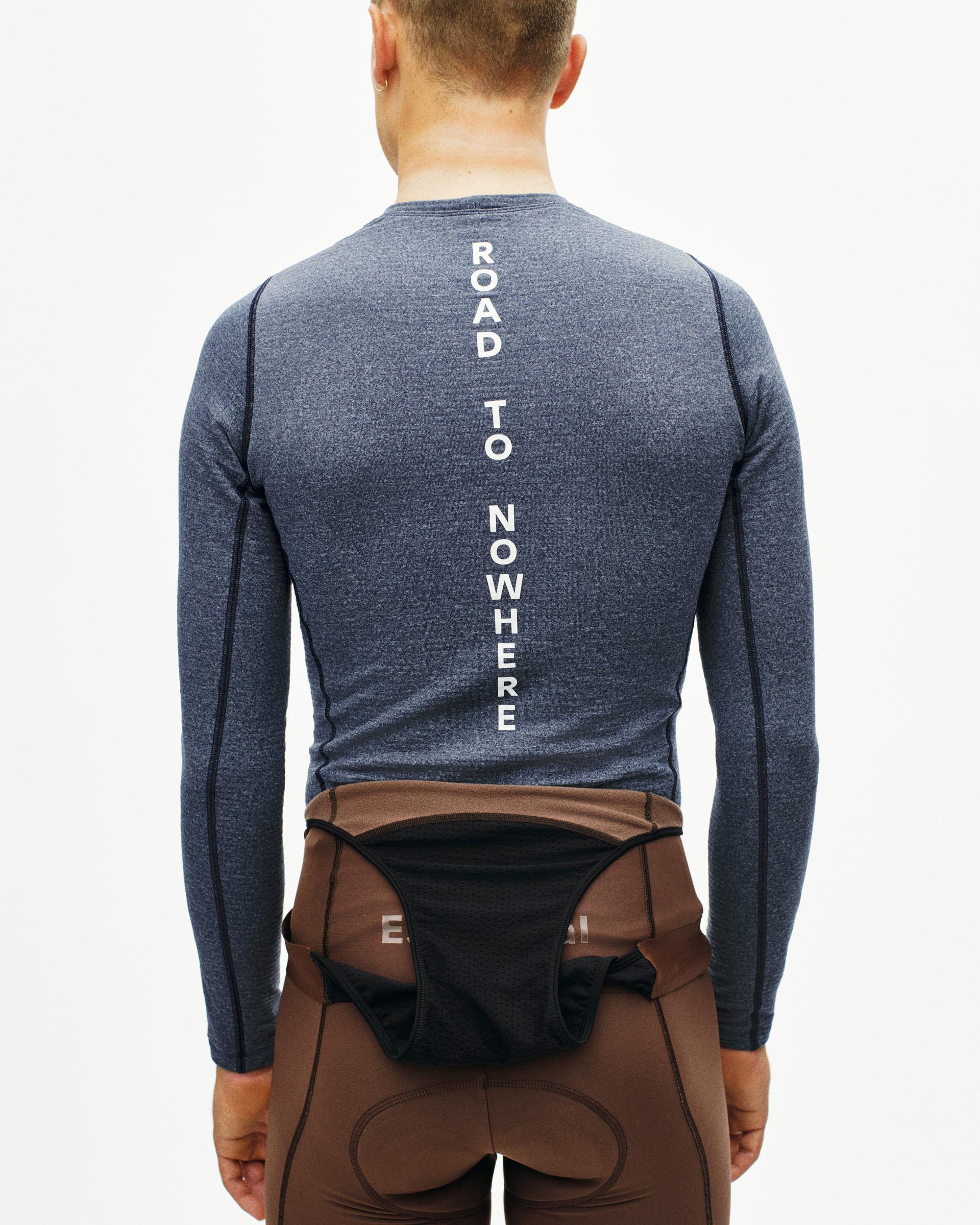 Navy thermal long sleeve base layer on model, rear view with white "ROAD TO NOWHERE" spine text