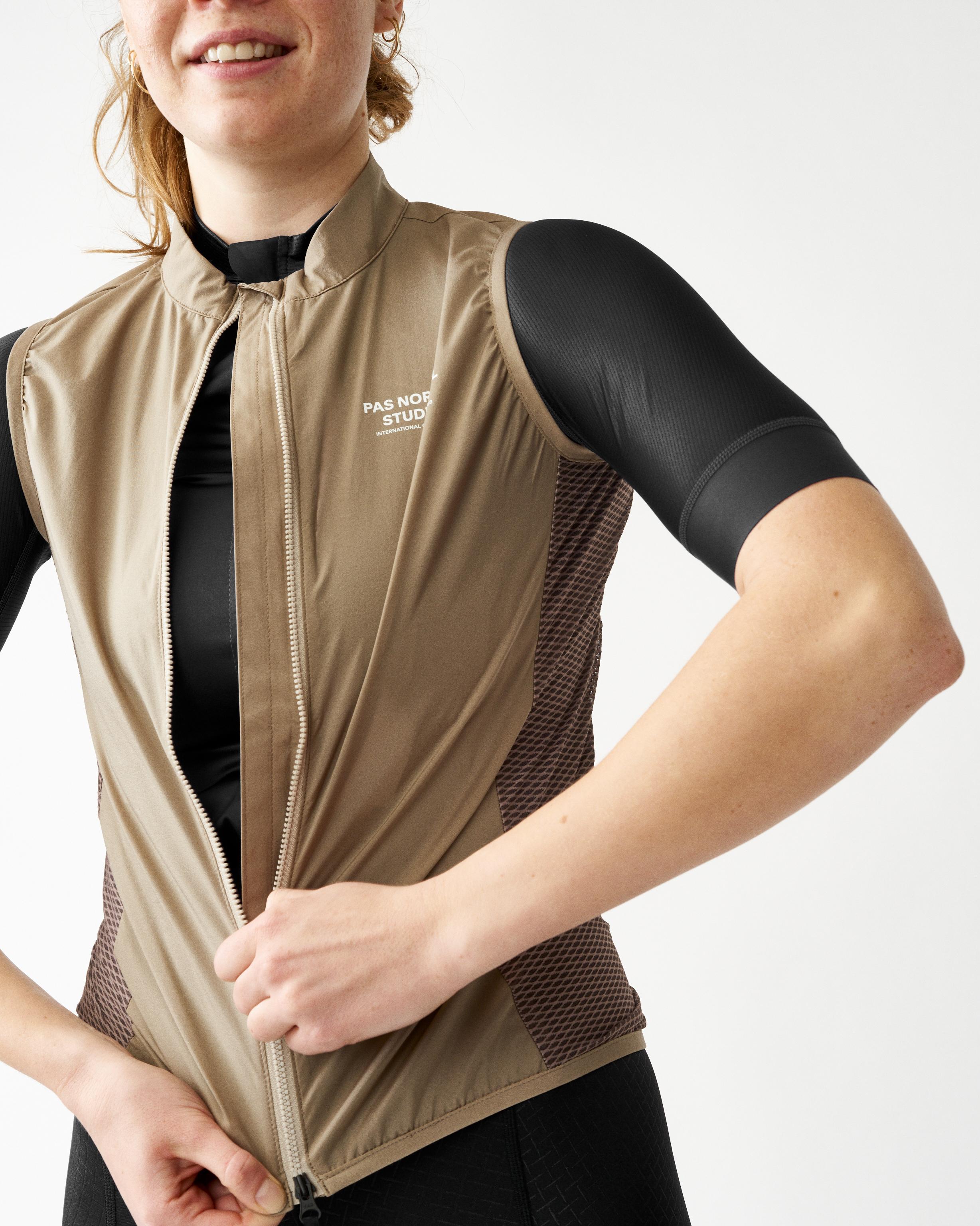 Beige Mechanism Stow Away gilet on model with mesh side panels