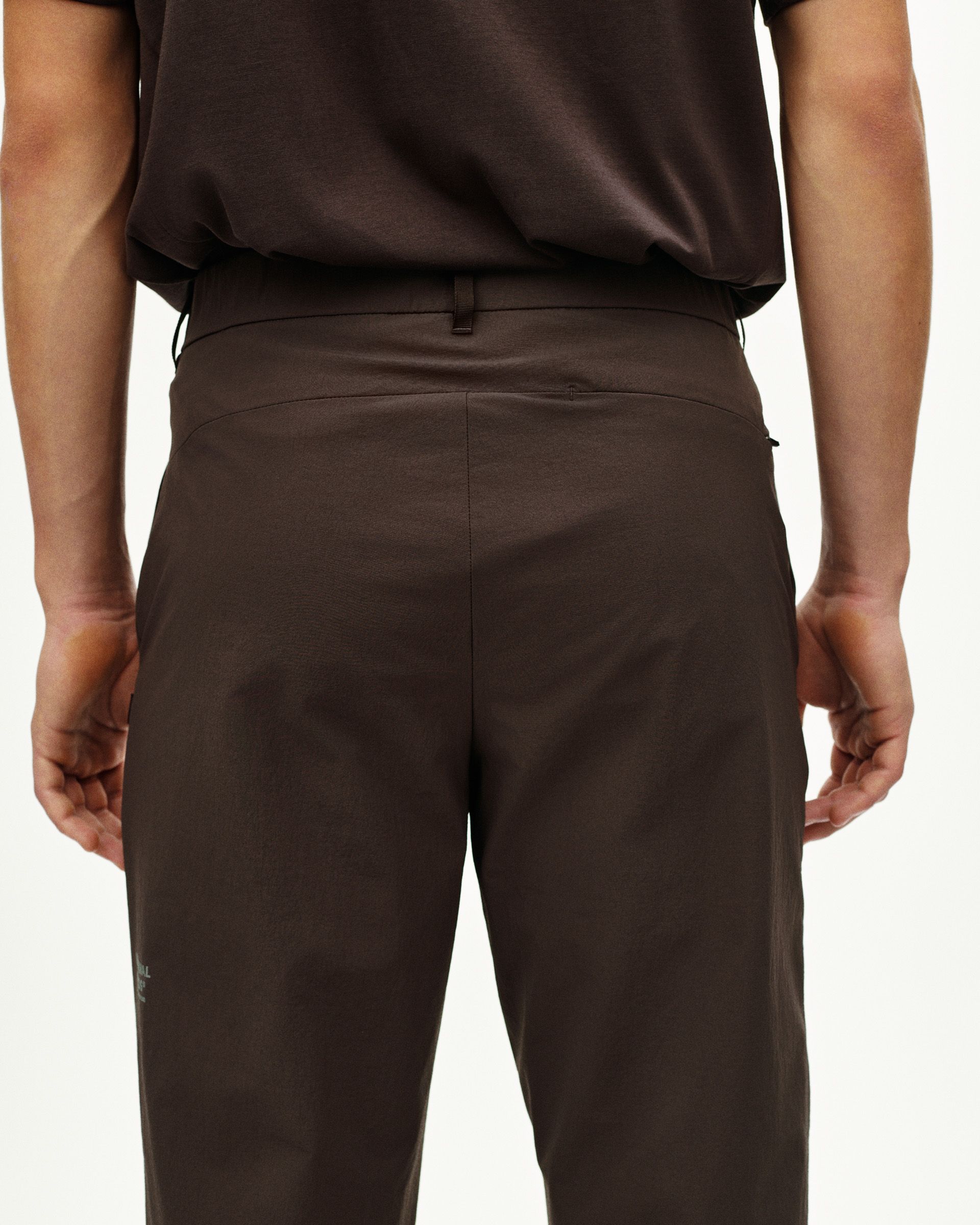 Dark Purple Off-Race Tech pants, rear view on model with tapered fit and back pocket detail