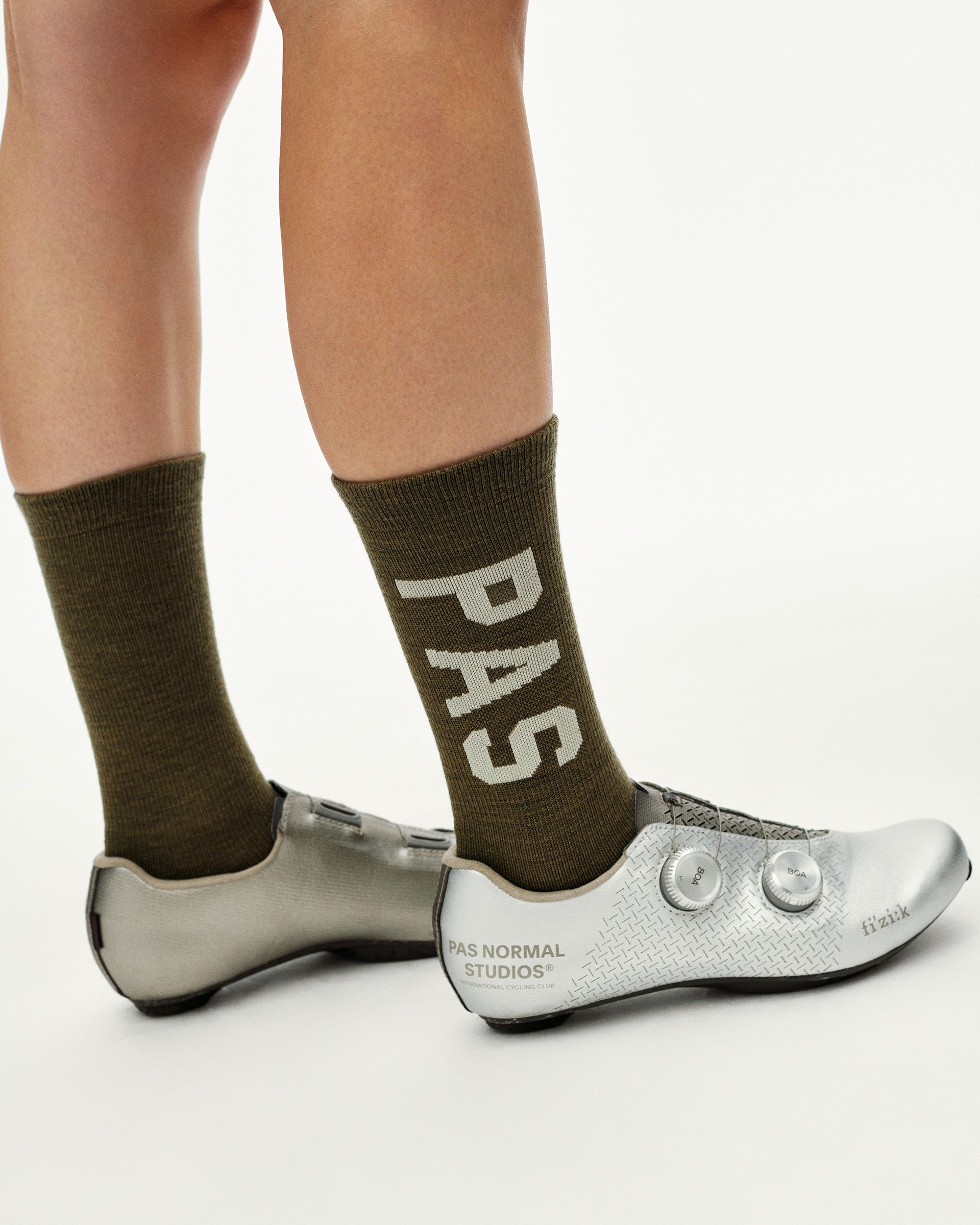 Moss Brown PAS Thermal Wool cycling socks on model, side view with large PAS logo print