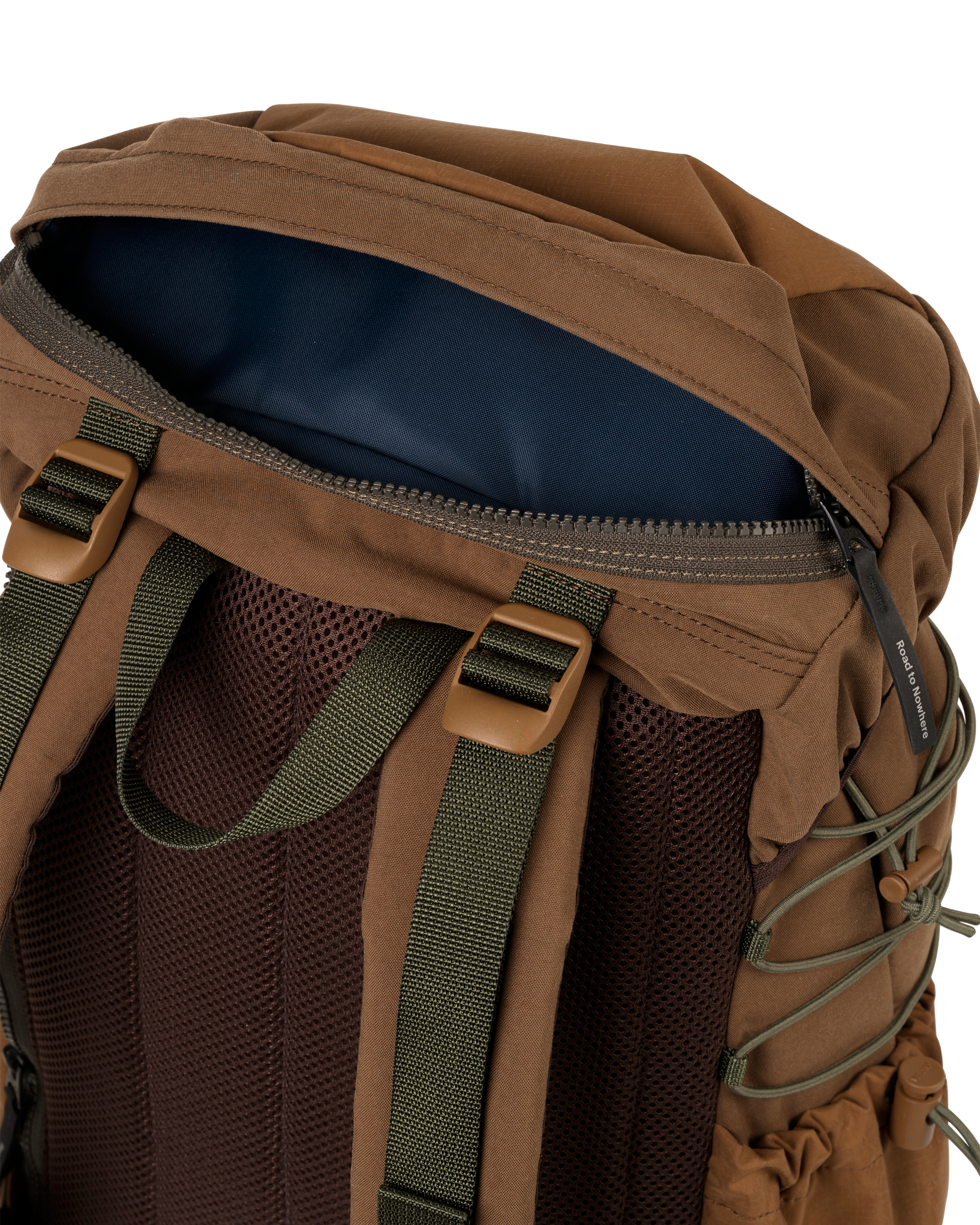 Light Brown Porter-Yoshida backpack, detail view of open top zip pocket with navy lining and olive shoulder straps