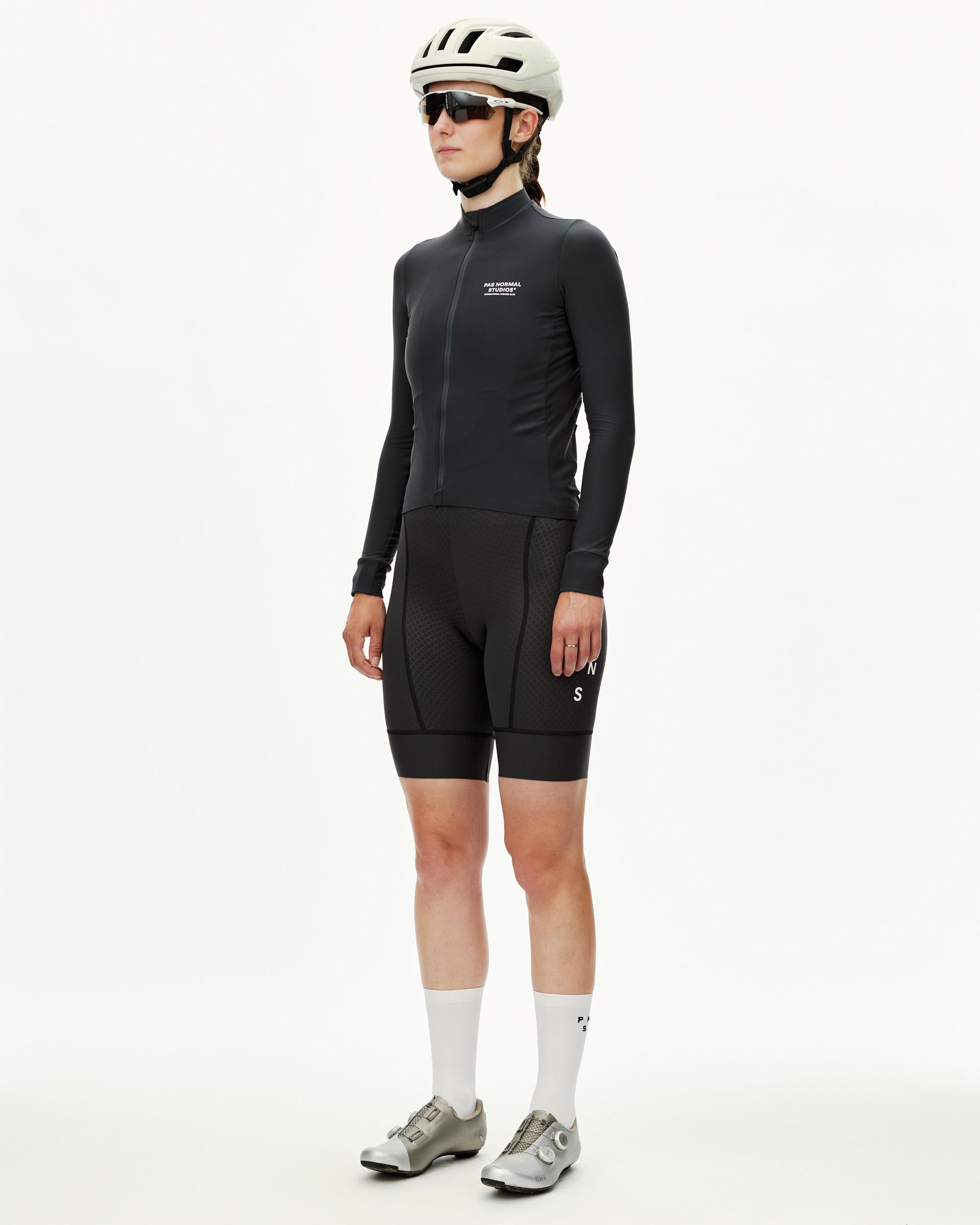 Dark Navy Mechanism women's long sleeve cycling jersey on model, three-quarter front view with white chest logo print