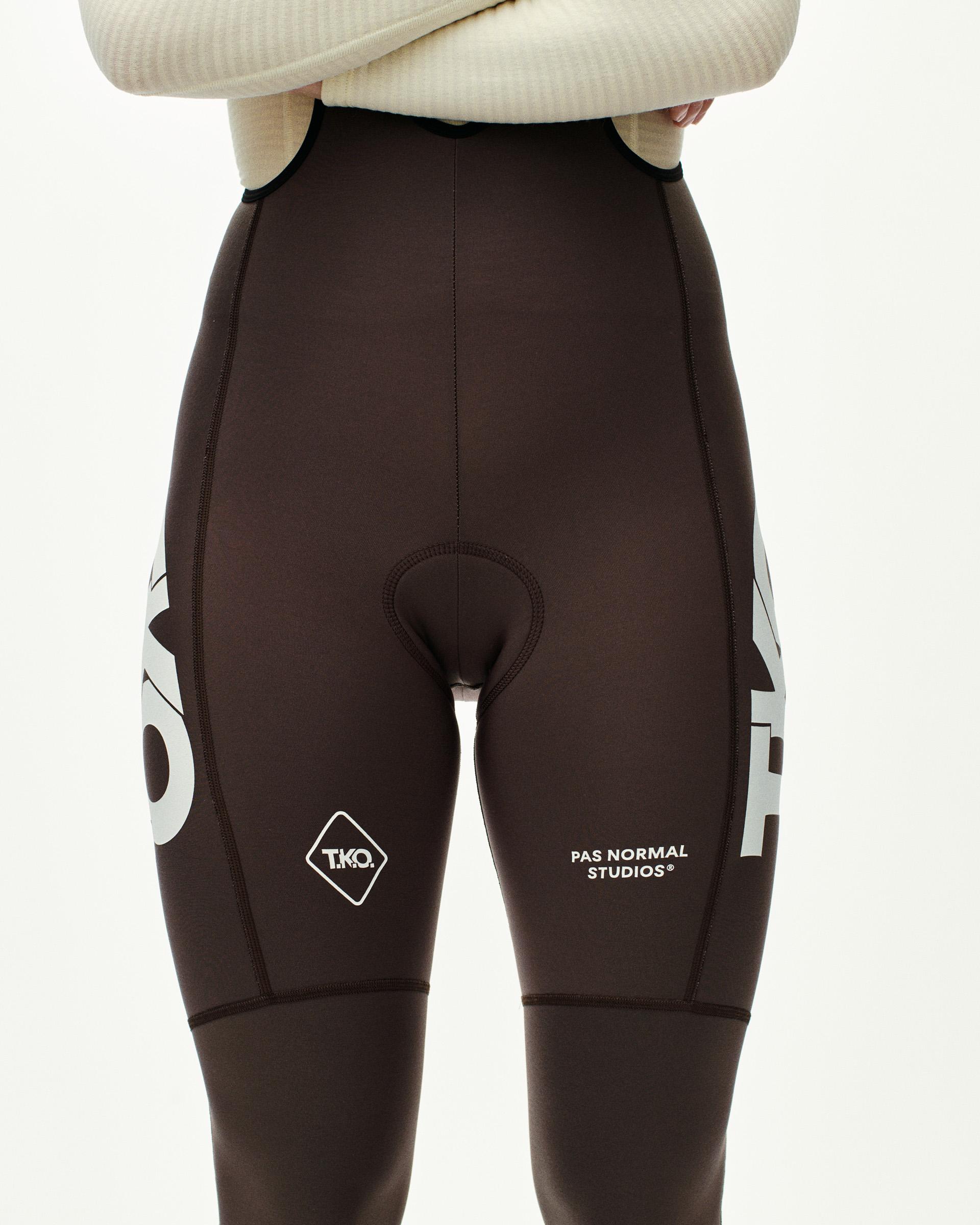 Dark Purple T.K.O. Essential Thermal women's cycling long bibs, front view on model with large white graphic print