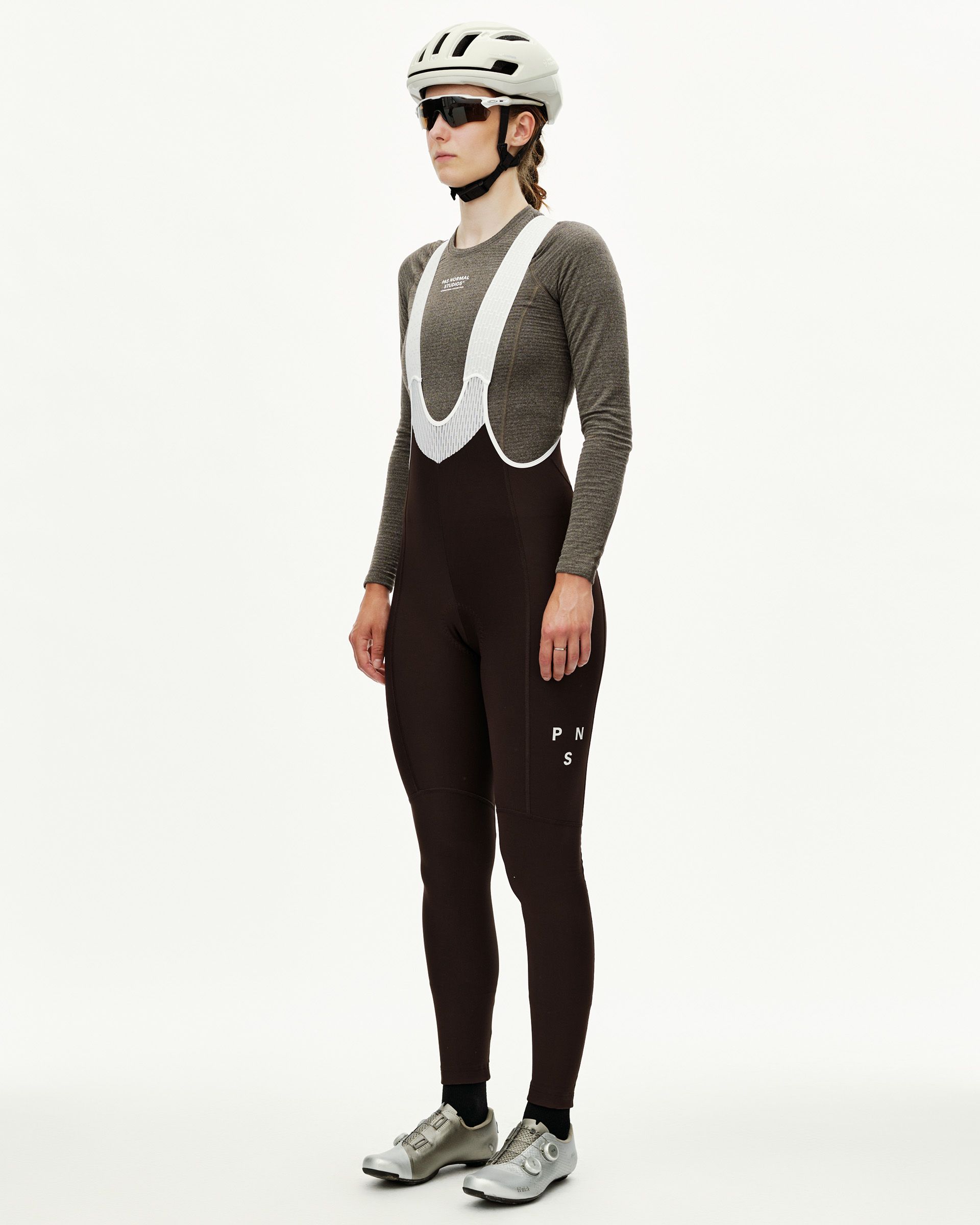 Dark Coffee Mechanism cycling bib tights on model, three-quarter front view with white mesh bib straps