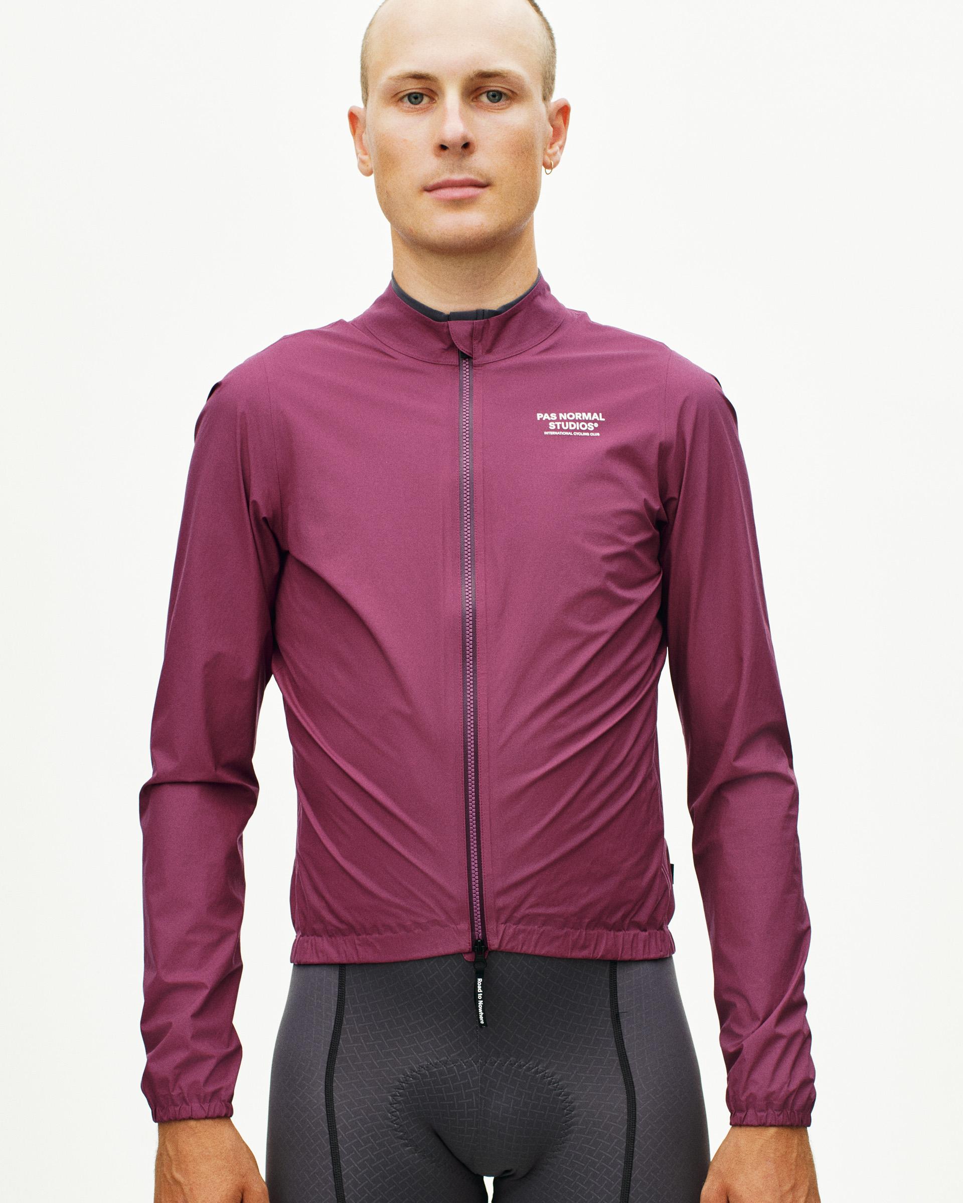 Purple Mechanism Rain cycling jacket on model with full zip and elastic cuffs