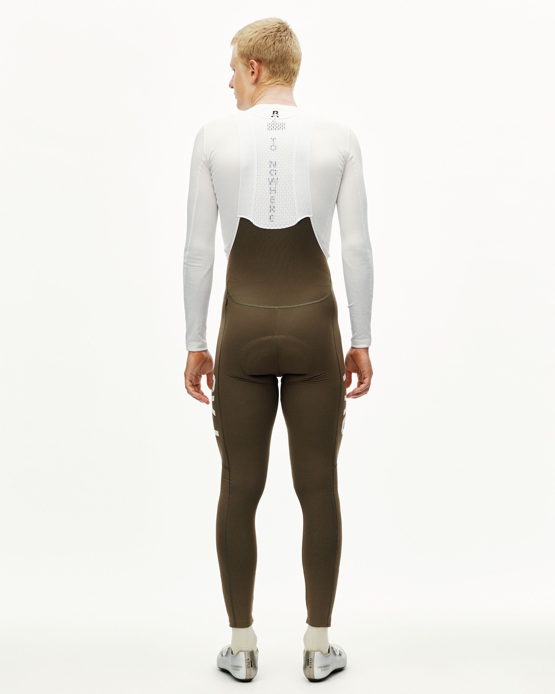 Dark Earth khaki PAS Mechanism Thermal Long cycling bib tights on model, rear view with reflective ankle details