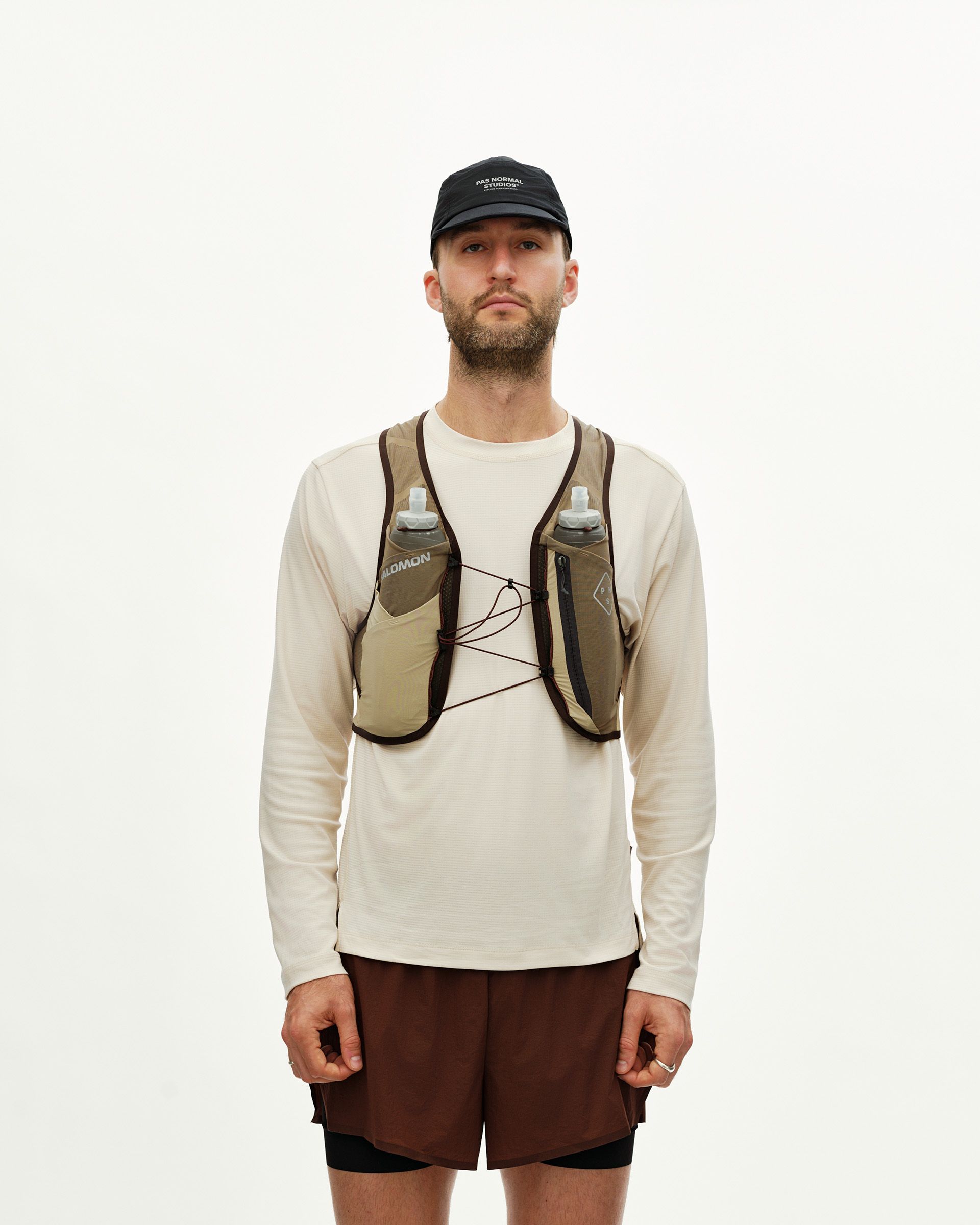 Light Brown Salomon Gravel Concept Skin 2 hydration vest on model, front view with two front bottles