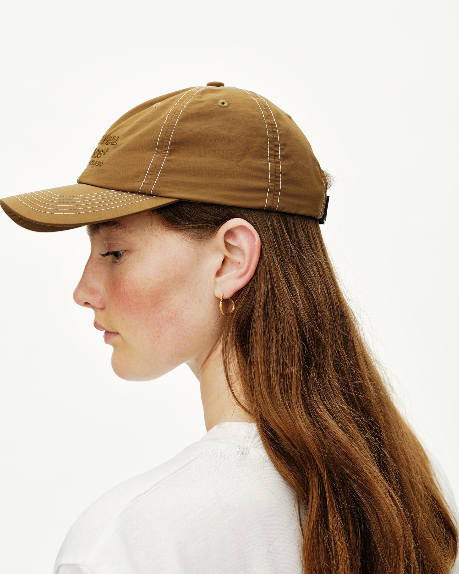 Wood brown Off-Race cap on model, side view with contrast white stitching and embroidered front logo