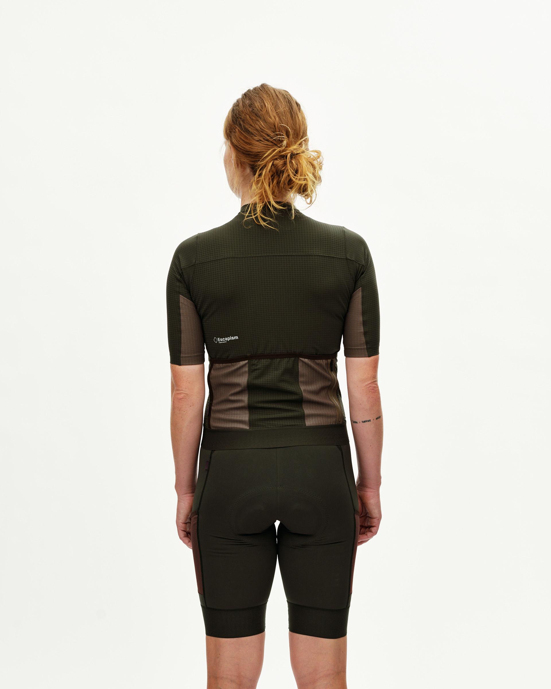 Dark Olive Escapism women's cycling jersey, rear view on model with mesh back pockets and tone-on-tone panels