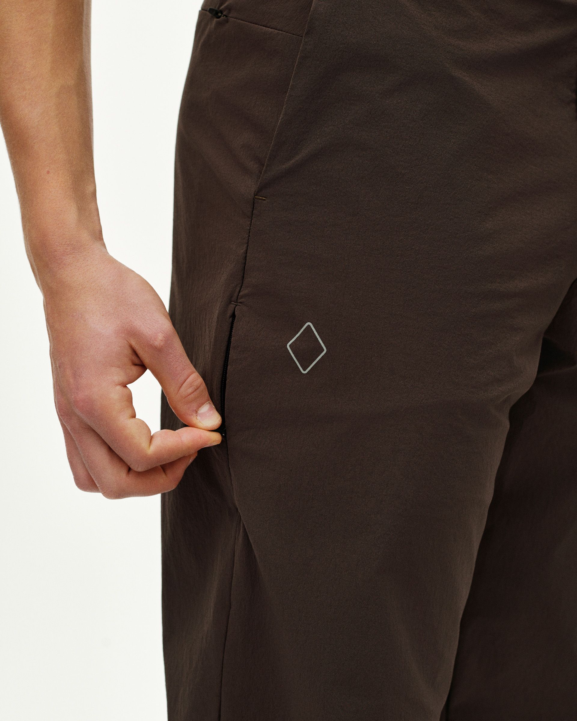 Dark Purple Off-Race Tech Pants on model showing side seam and white diamond logo