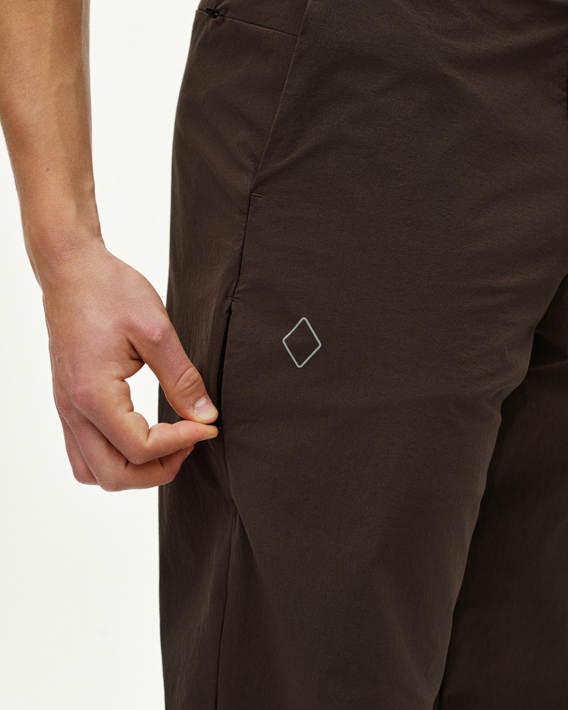 Dark Purple Off-Race Tech Pants on model showing side seam and white diamond logo