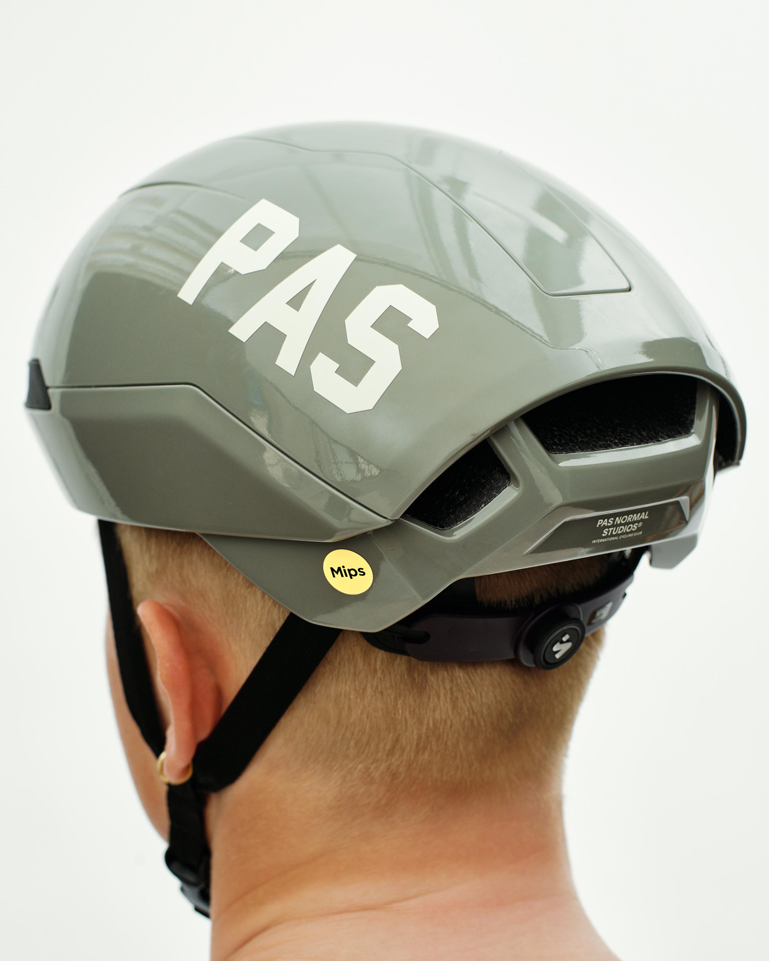 Grey PAS Tucker III 2Vi MIPS cycling helmet on model with white PAS logo and yellow MIPS sticker