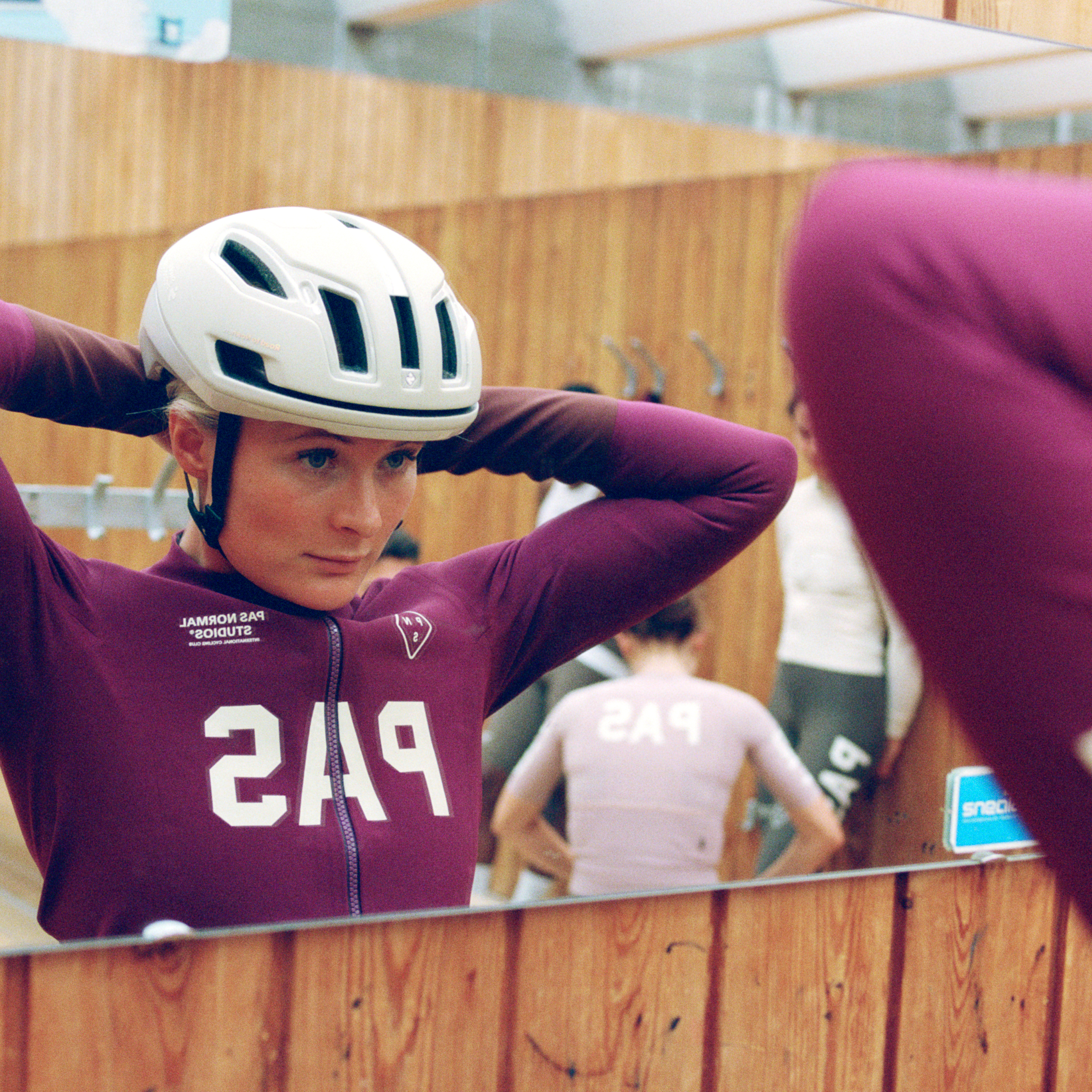 Burgundy PAS Mechanism women's thermal long bibs on model, front view with white chest logo print