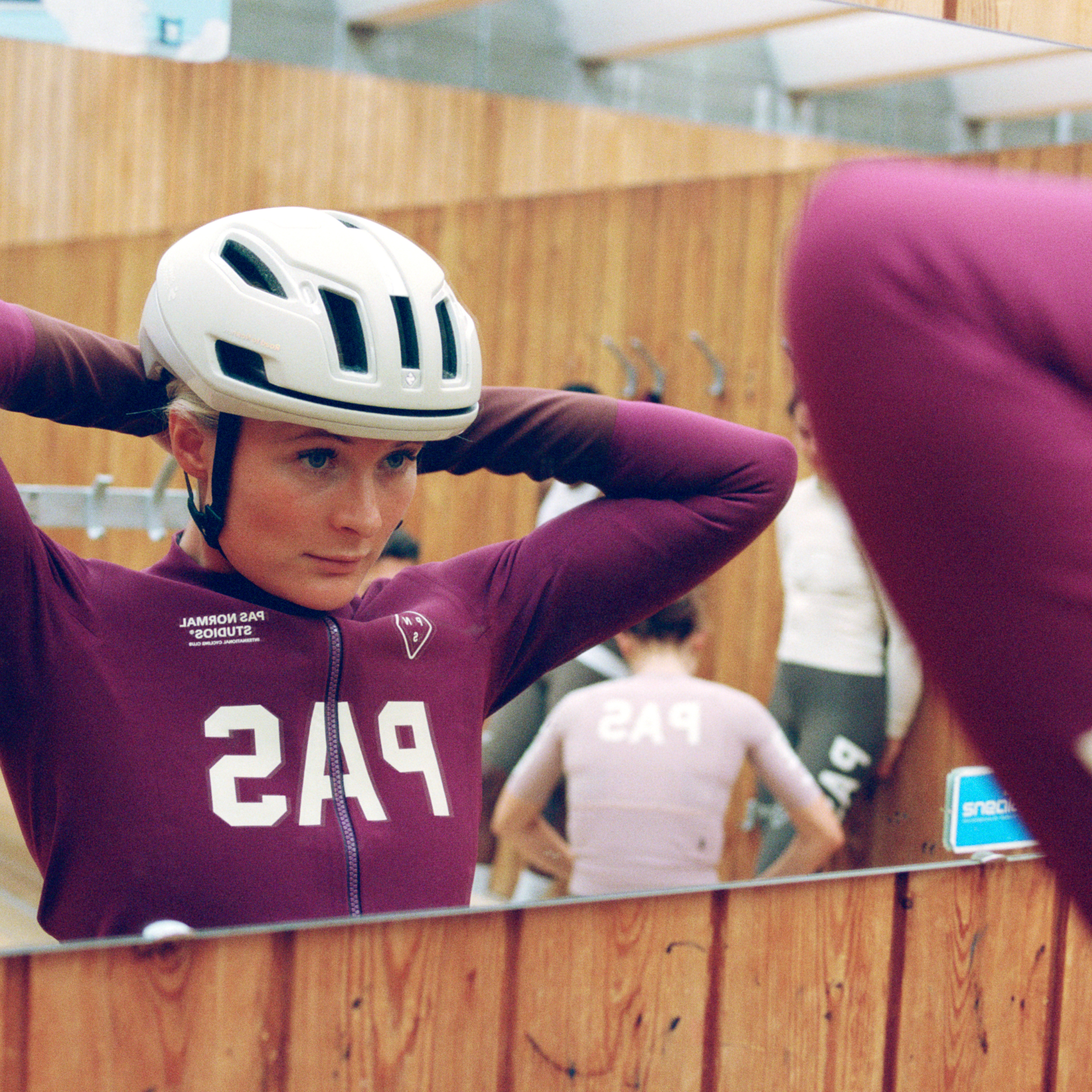 Burgundy PAS Mechanism women's thermal long bibs on model, front view with white chest logo print