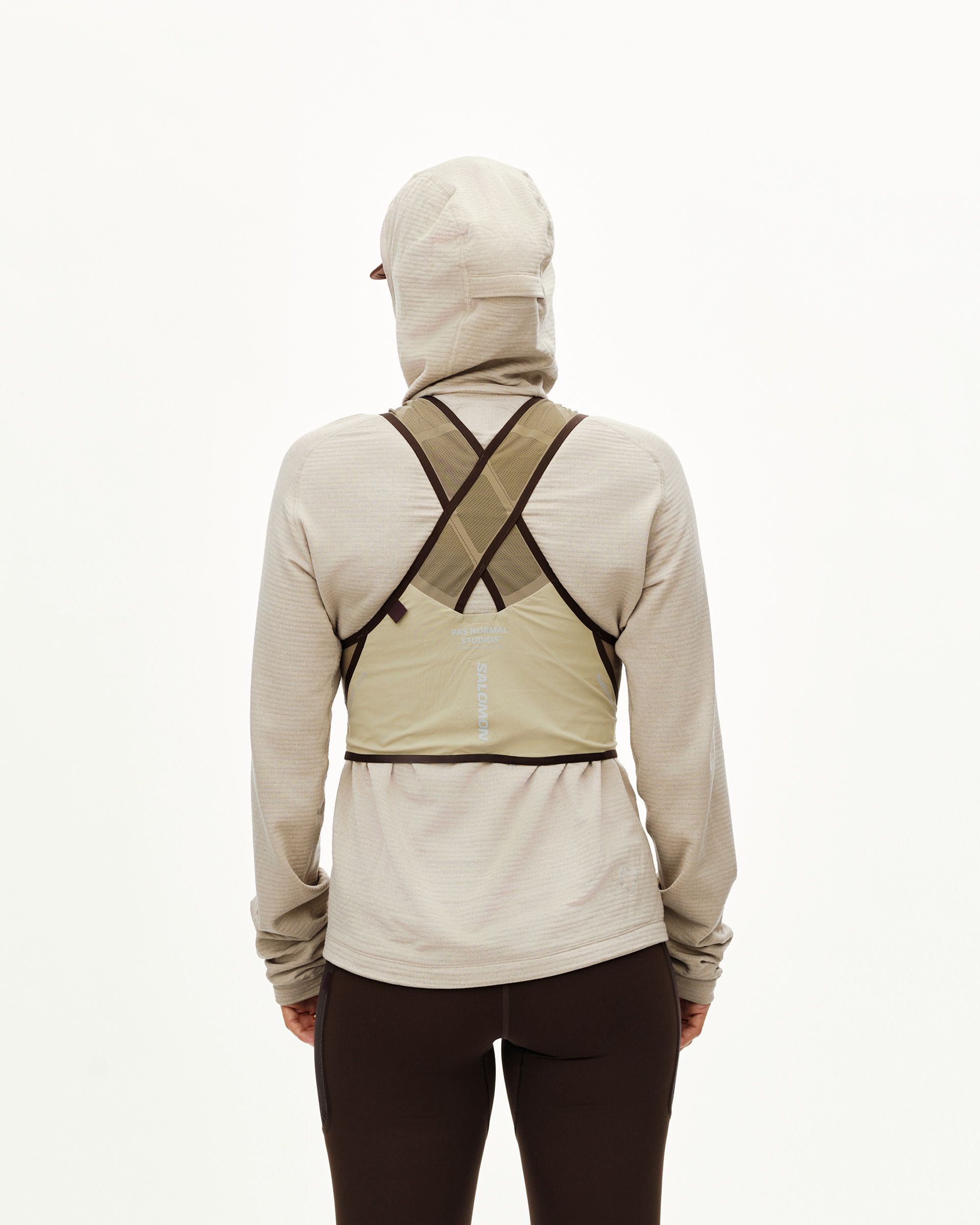 Light Brown Salomon Gravel Concept Skin 2 vest on model, rear view with cross-back harness straps