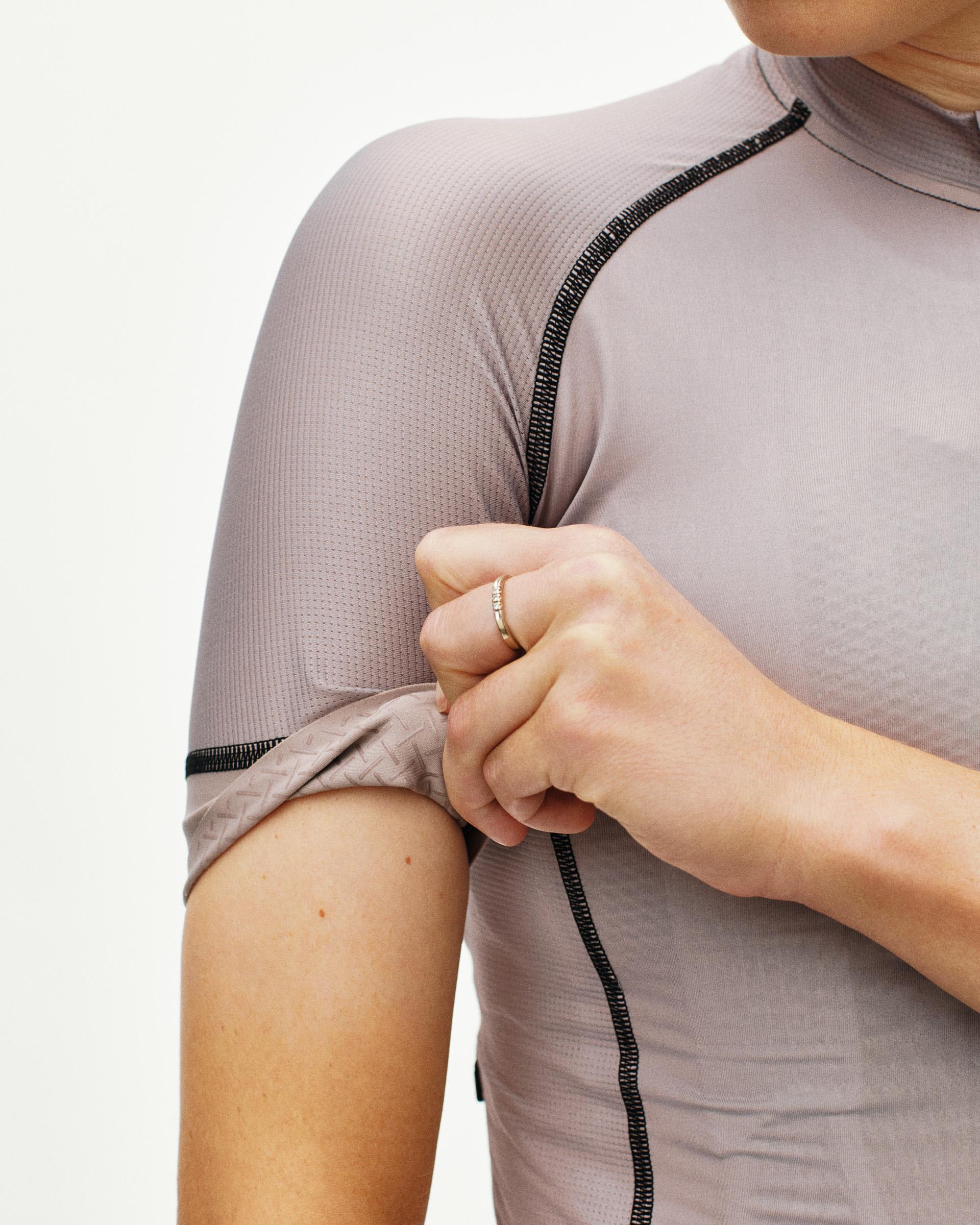 Grey Mechanism cycling jersey on model showing contrast stitching and textured shoulder panel