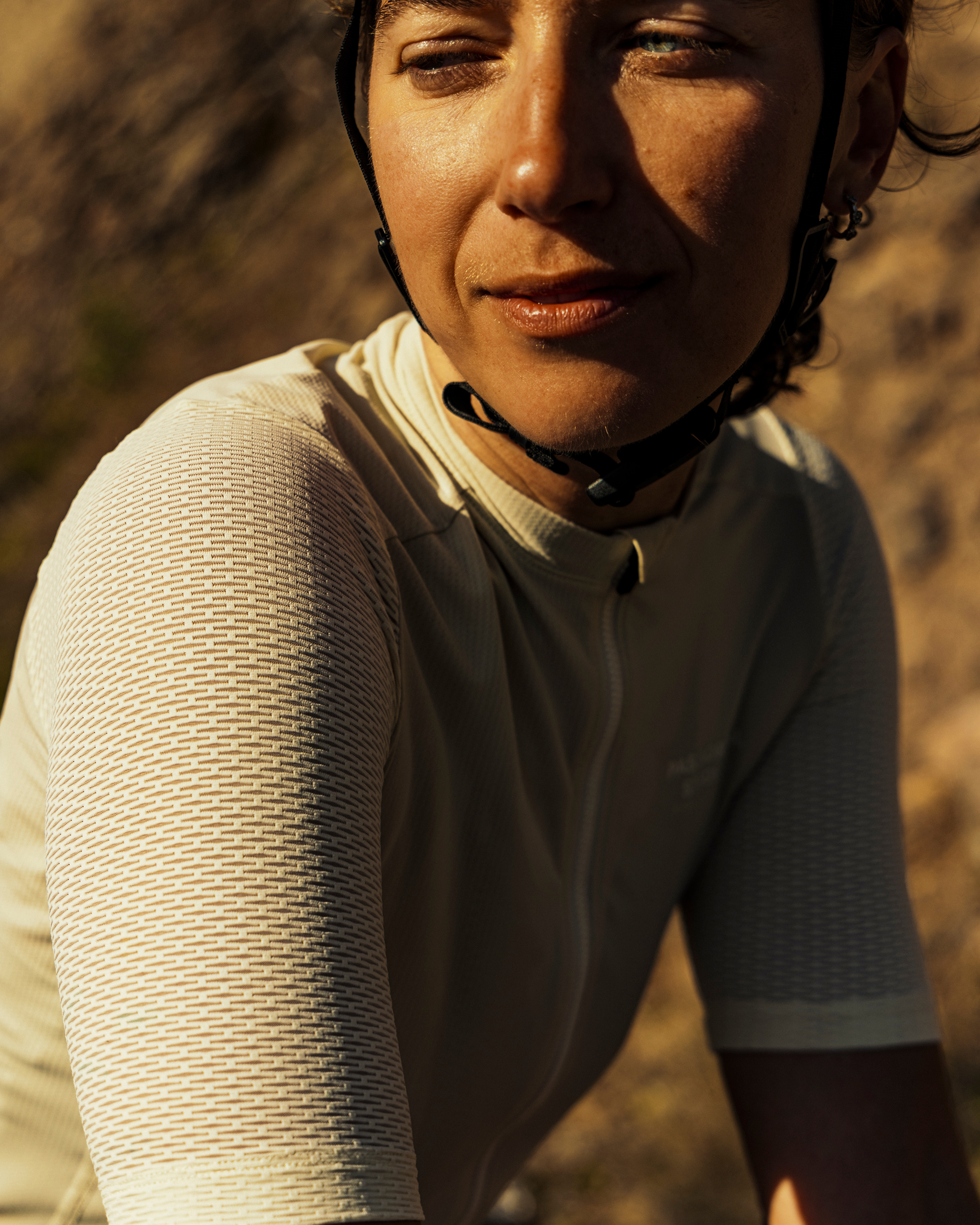 Model wearing Essential Light base layer with textured long sleeves in warm sunlight