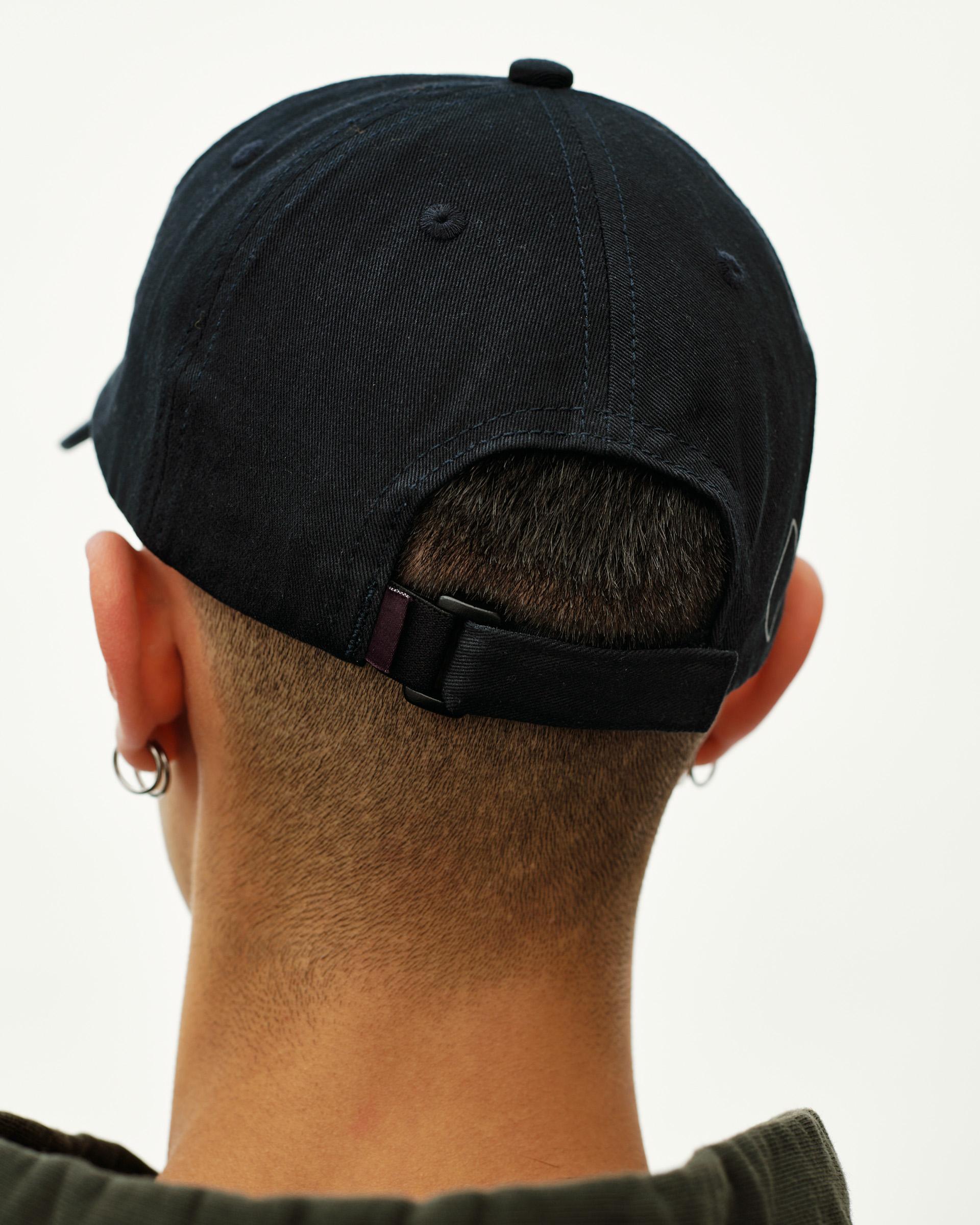 Black Off-Race Cotton Cap, rear view on model showing adjustable strap closure