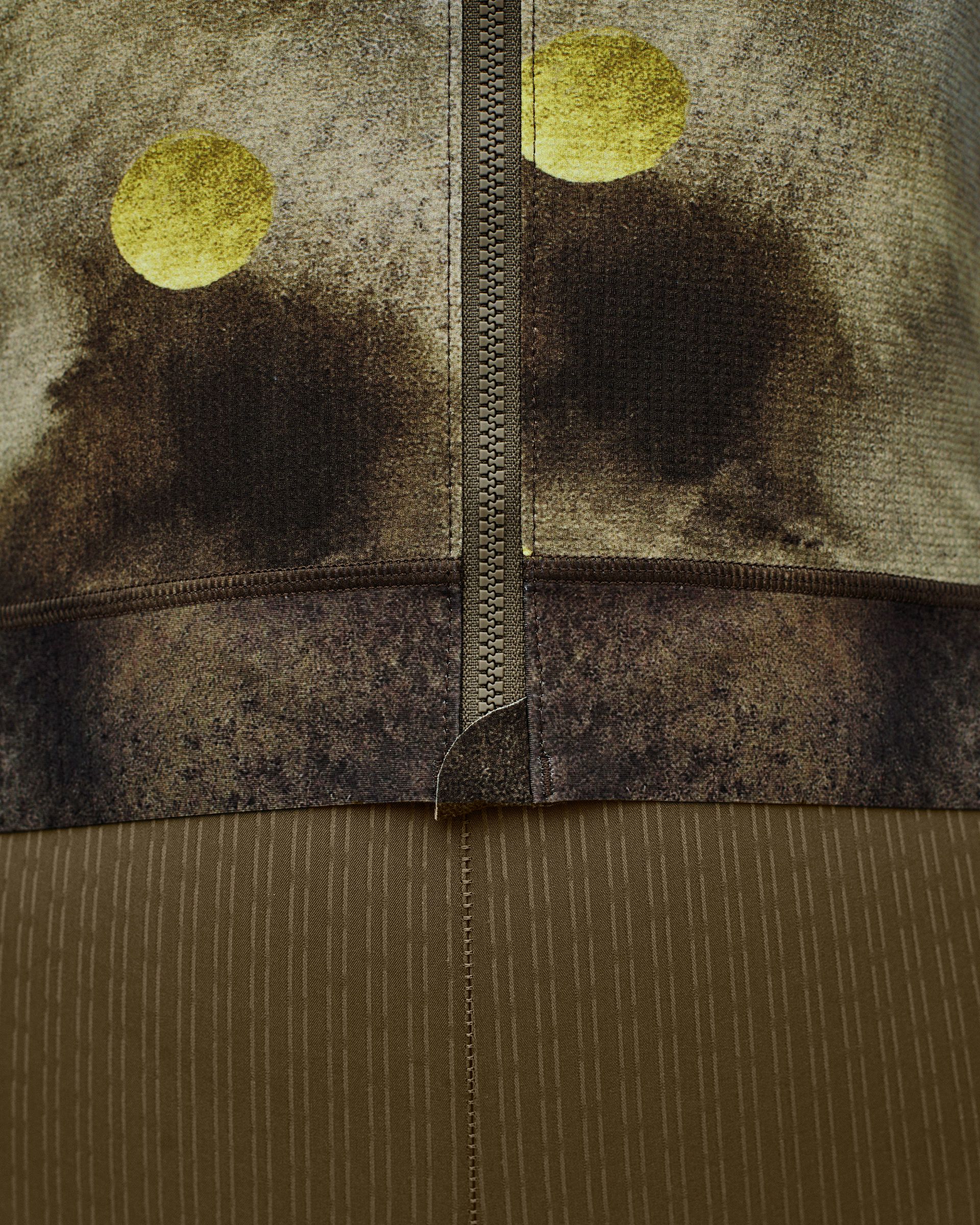 Green T.K.O. Essential Light cycling jersey, detail view with yellow dot print and contrast zip