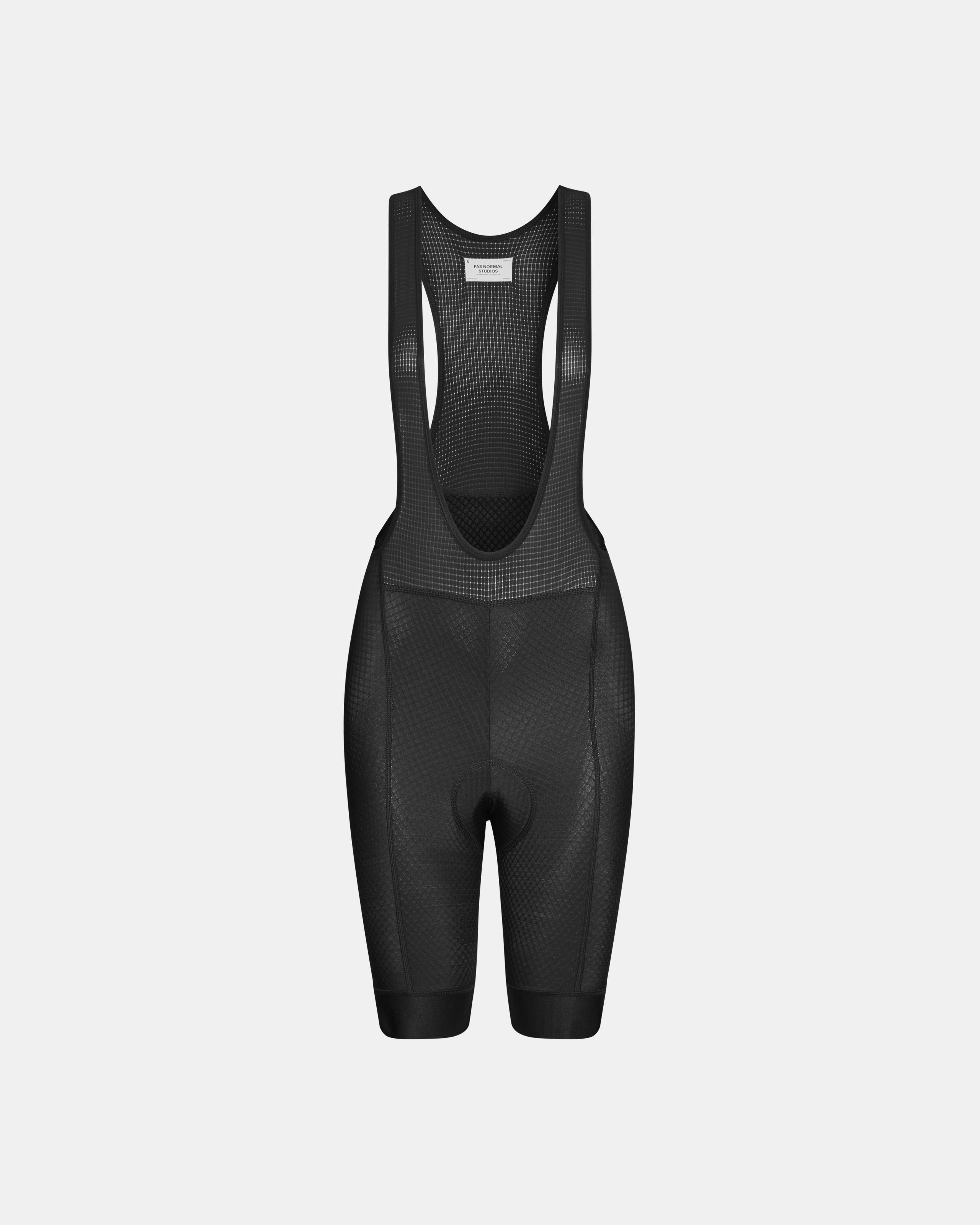 Black Essential cycling bibs, front flat lay with mesh bib straps