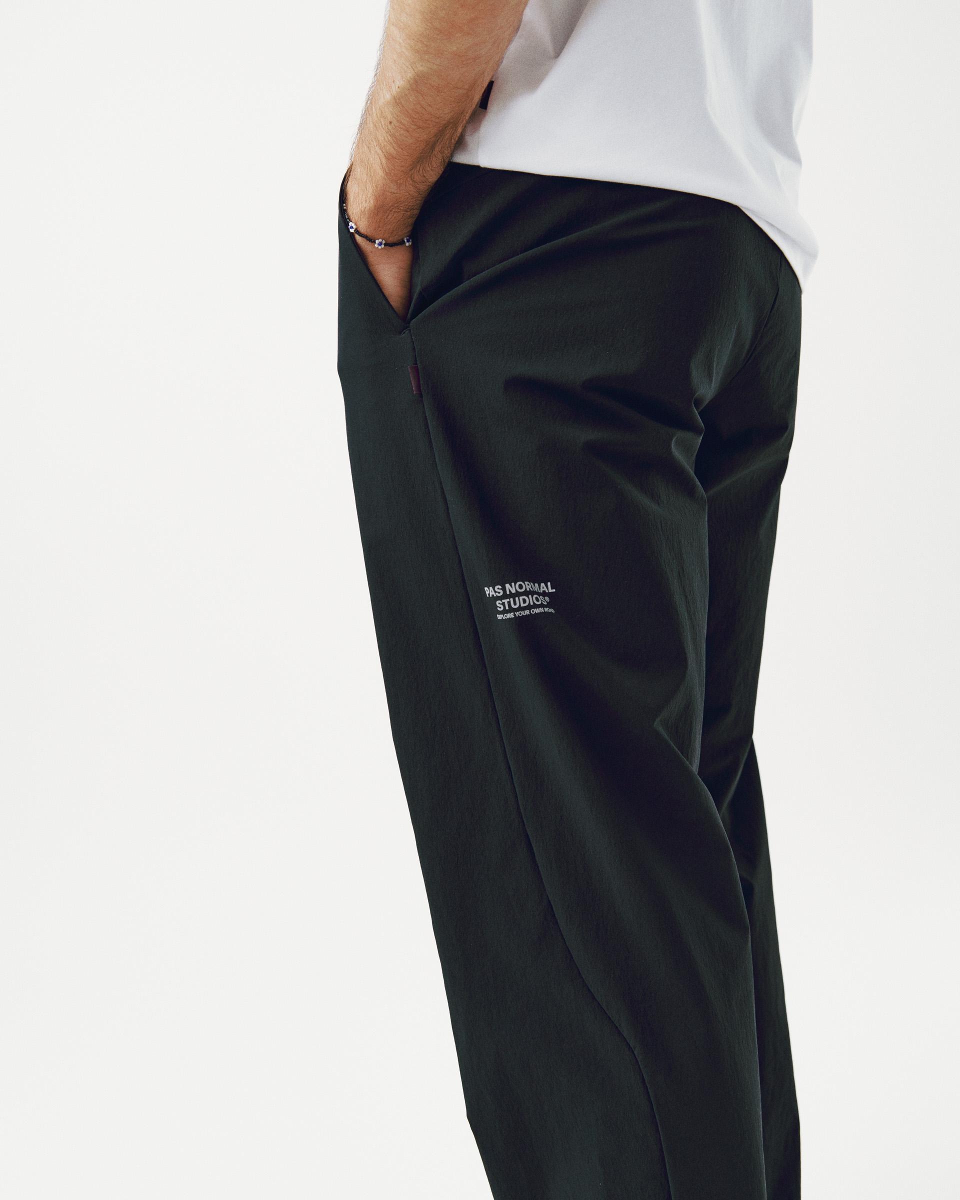 Black Off-Race Tech pants on model, side view with white leg logo