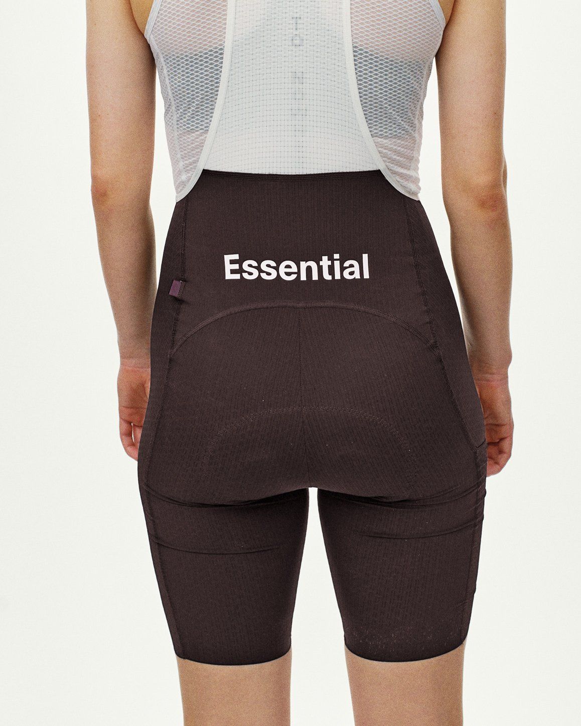 Dark Purple Essential Light Cargo bibs on model, rear view with white Essential logo print