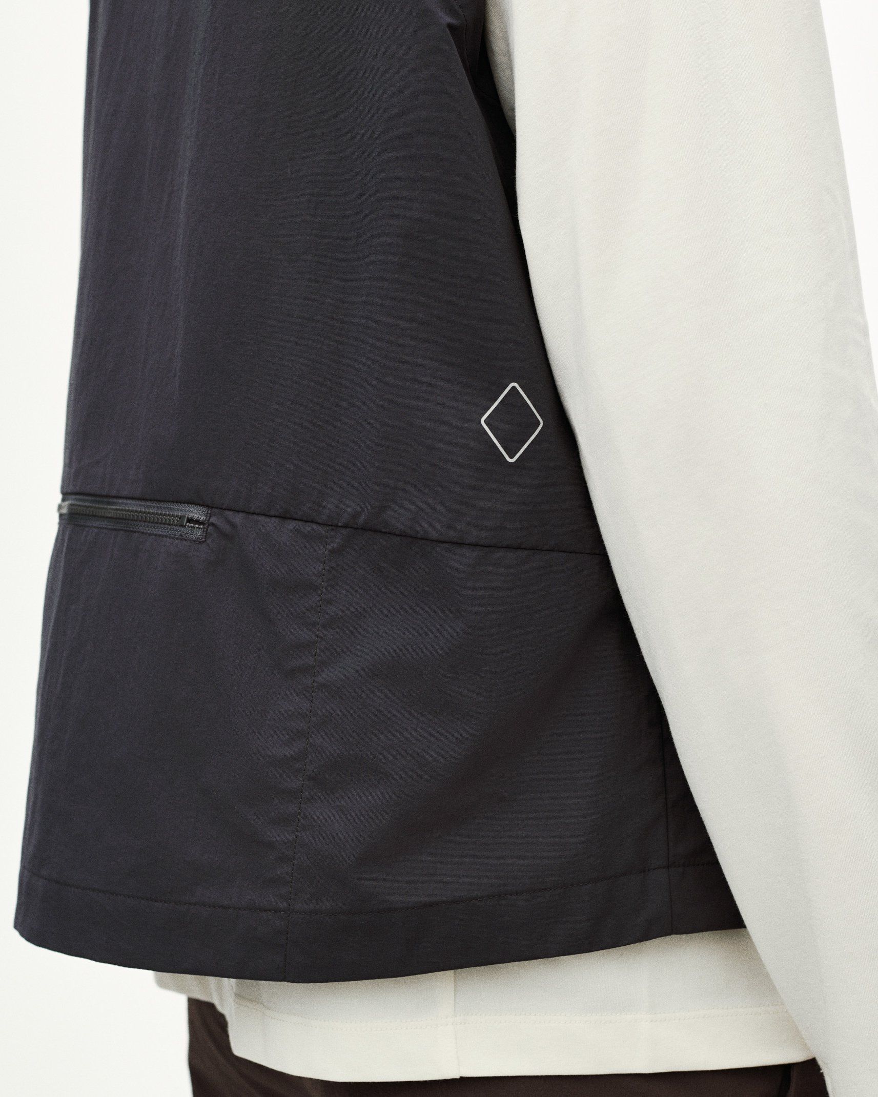 Grey Off-Race Utility vest, side detail view showing zip pocket and diamond logo