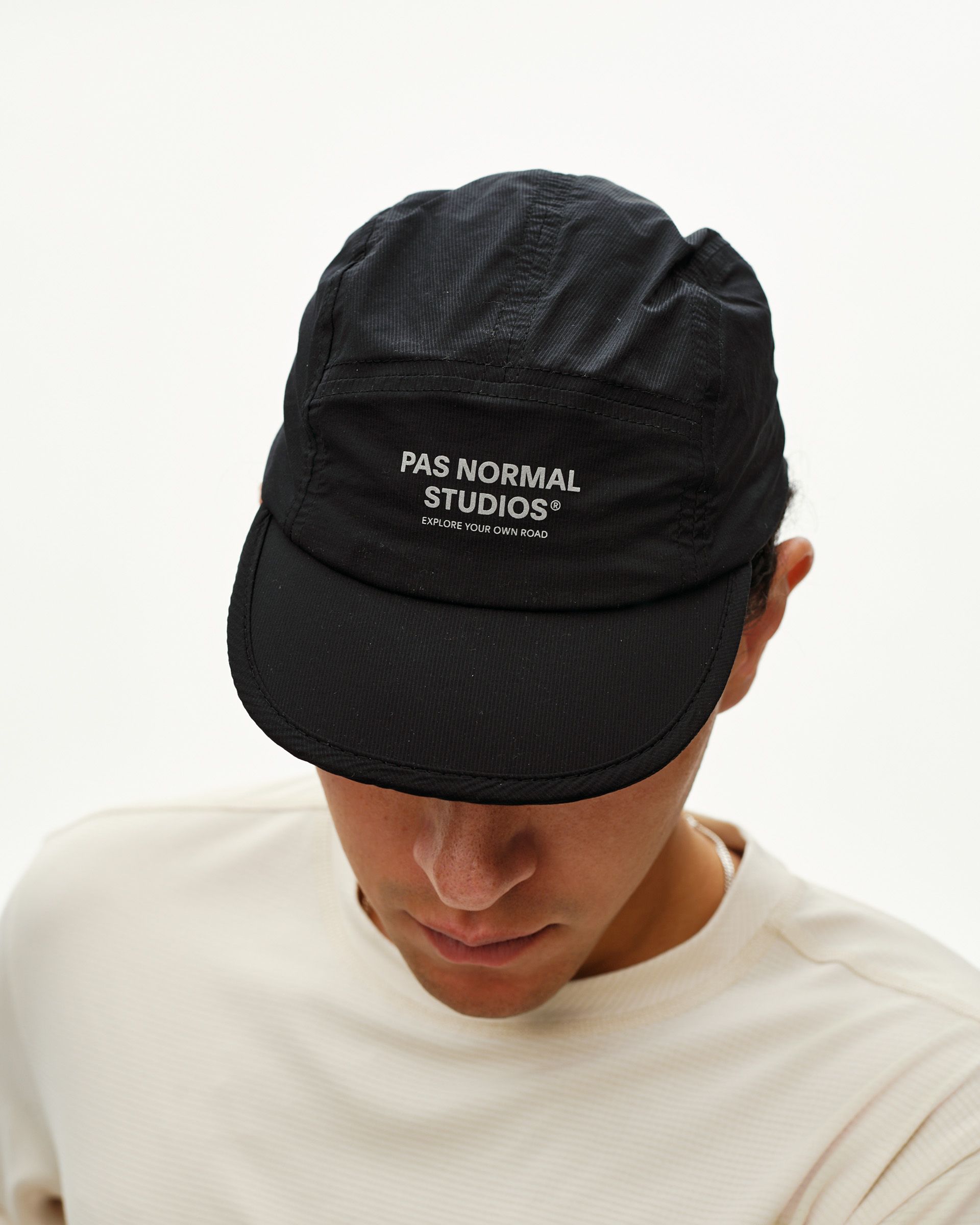 Black Balance cap on model, front view with grey logo print on panel