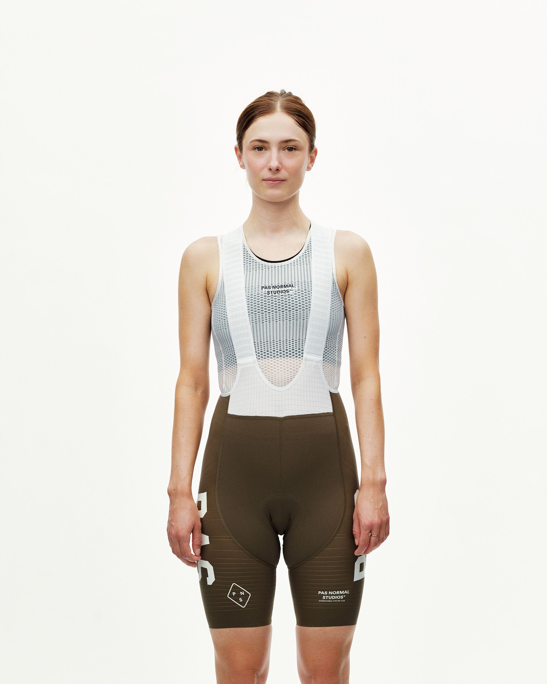 Dark Earth khaki PAS Mechanism Pro women's cycling bibs on model, front view with white mesh bib straps