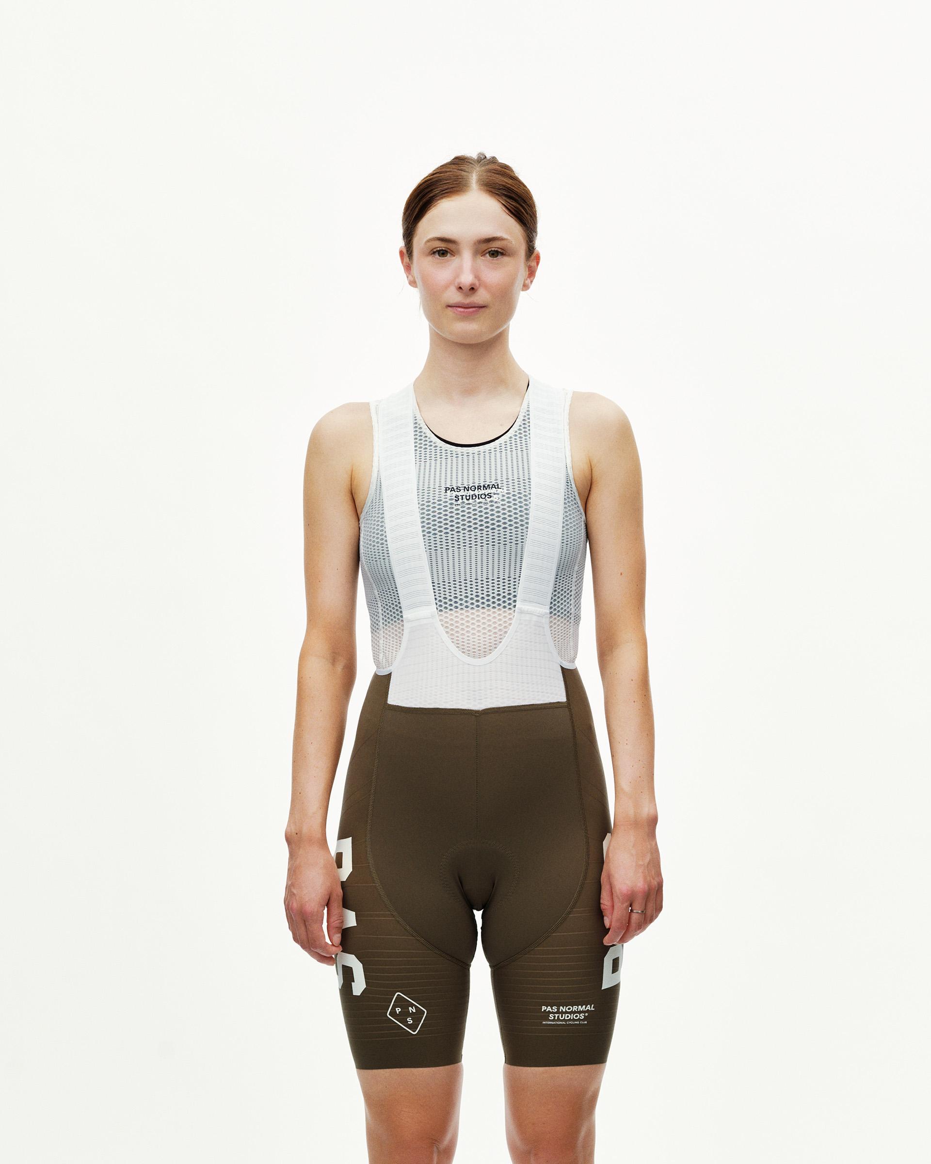 Dark Earth khaki PAS Mechanism Pro women's cycling bibs on model, front view with white mesh bib straps
