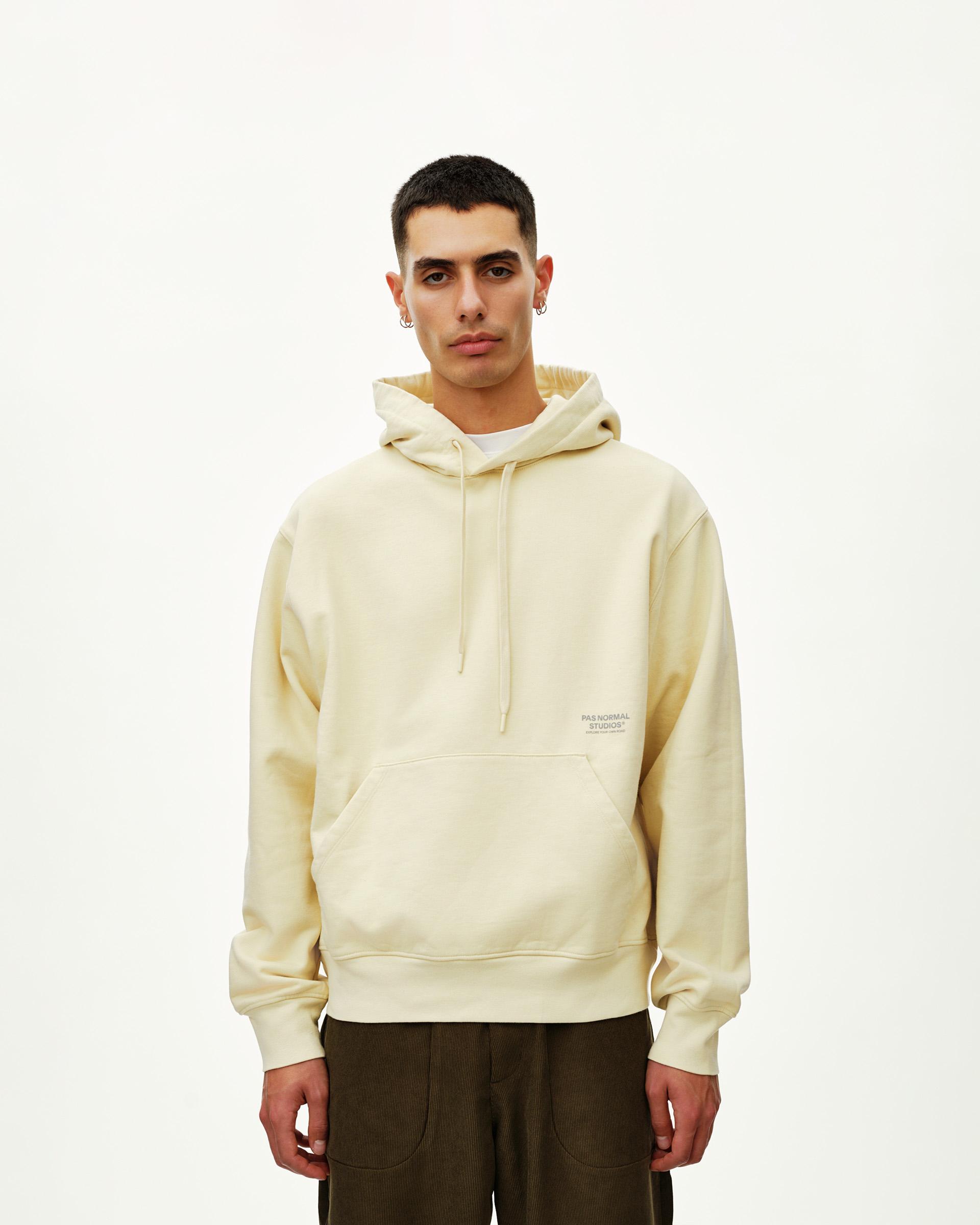 Sand Off-Race hoodie on model, front view with kangaroo pocket and chest text print