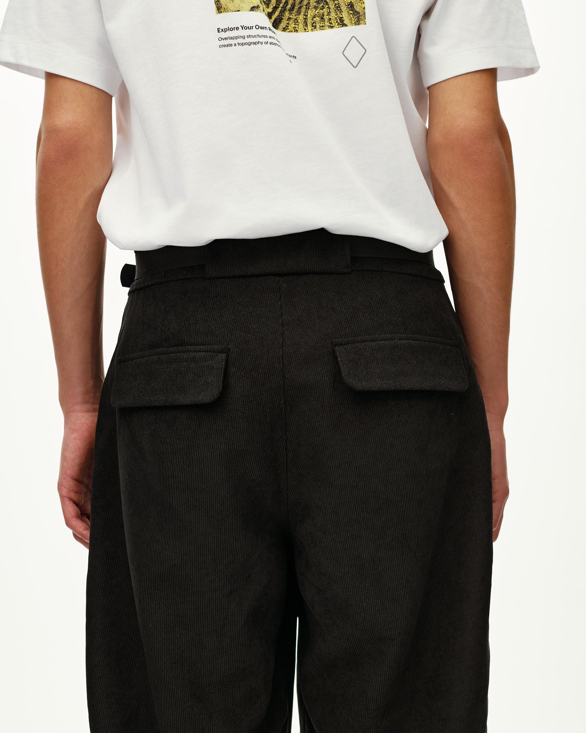 Black Off-Race Corduroy pants, rear view on model with patch pockets and belted waistband
