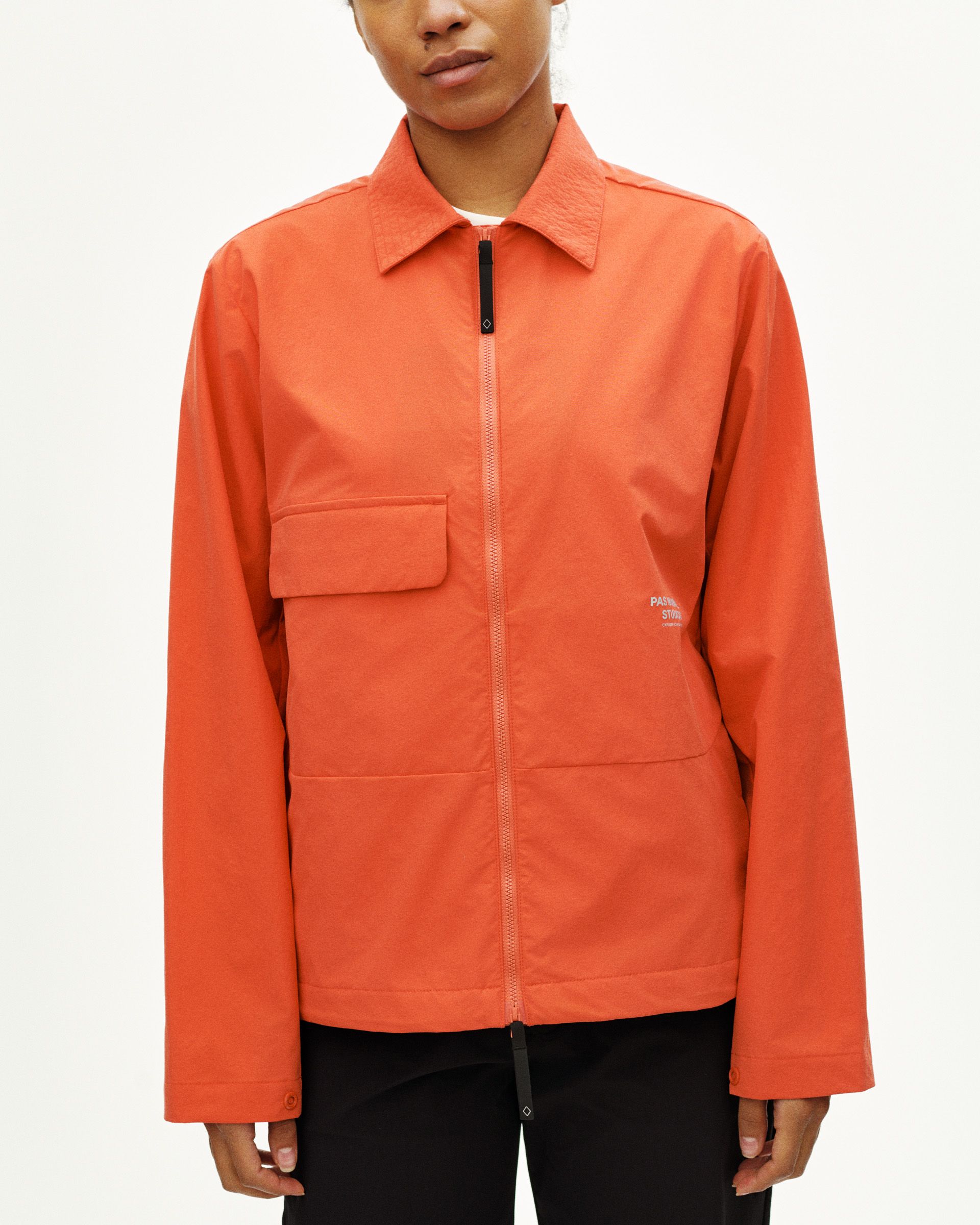 Orange Off-Race Utility jacket on model with chest pocket and full zip