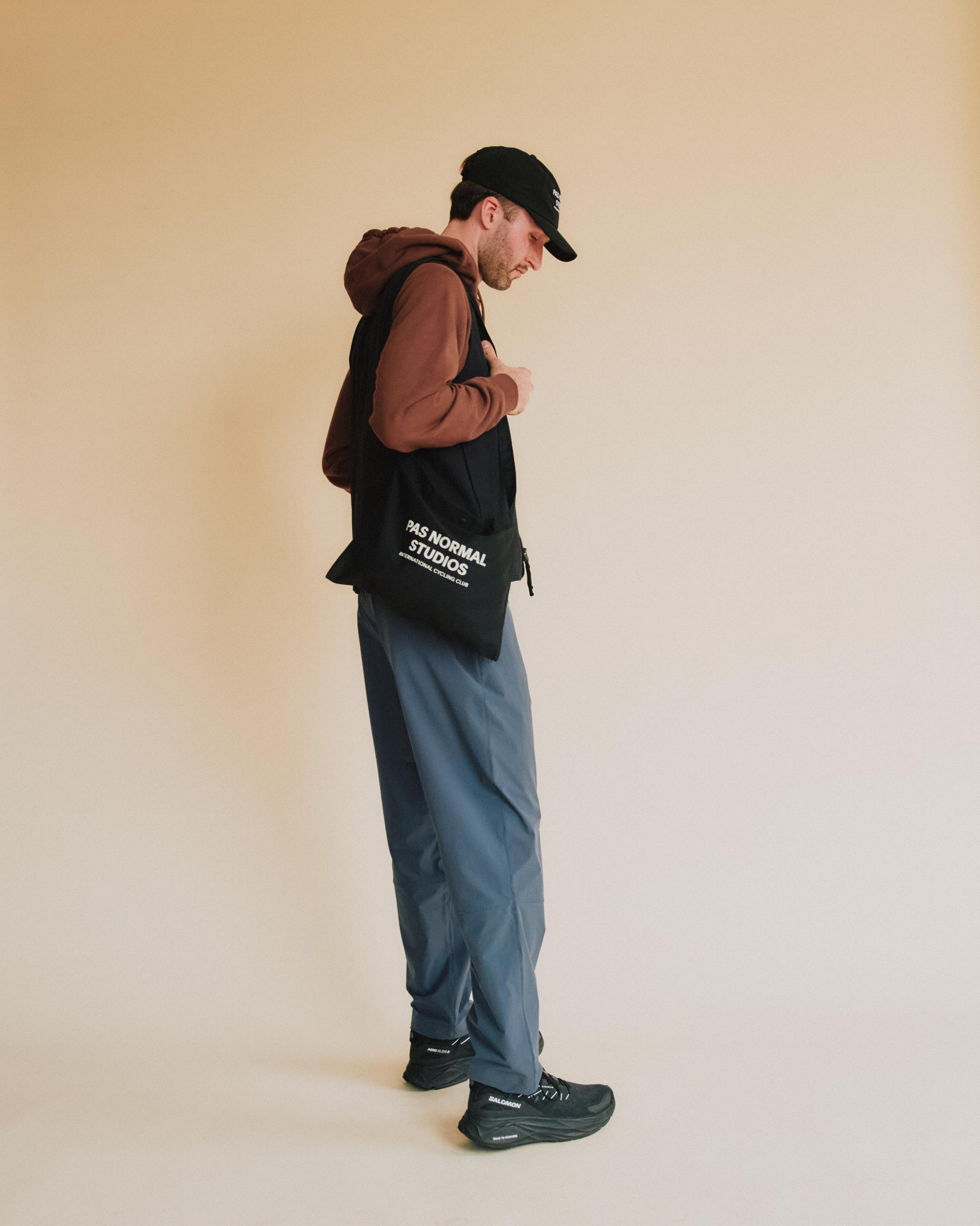 Blue Off-Race pants on model, side view with relaxed fit