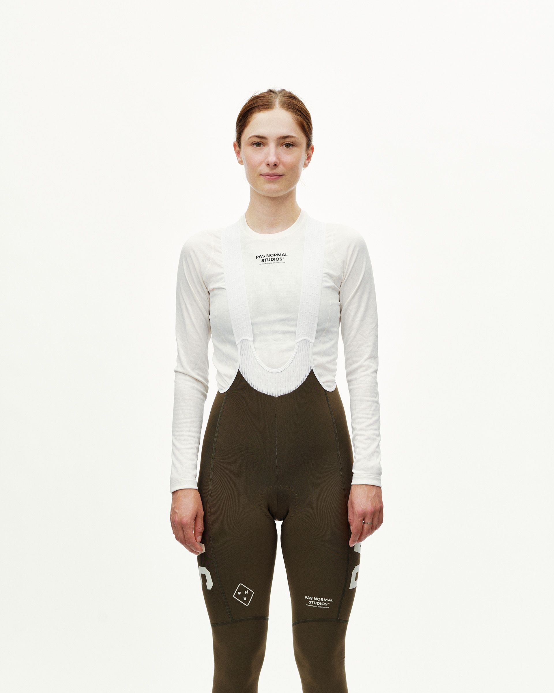 Dusty Earth khaki PAS Mechanism women's thermal long cycling bibs, front view on model with white bib straps