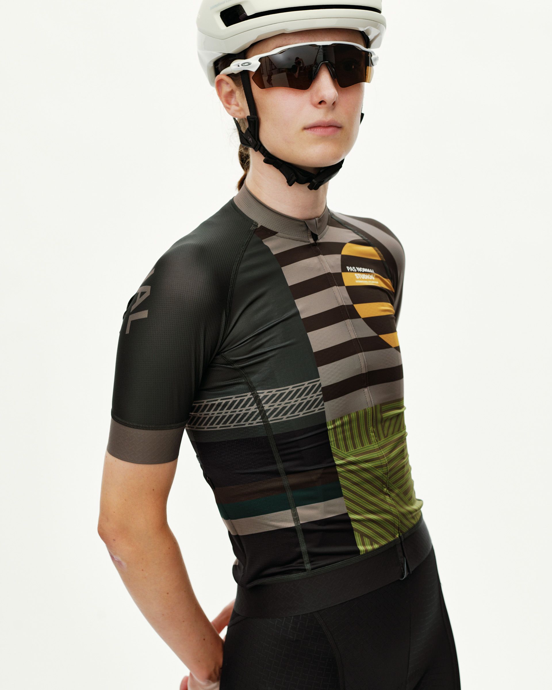 International Earth Mechanism women's cycling jersey on model, three-quarter front view with multicolor geometric stripes