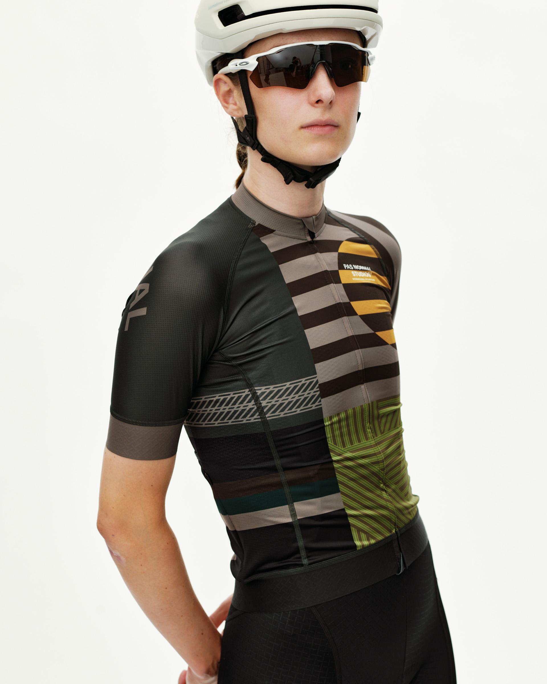 International Earth Mechanism women's cycling jersey on model, three-quarter front view with multicolor geometric stripes