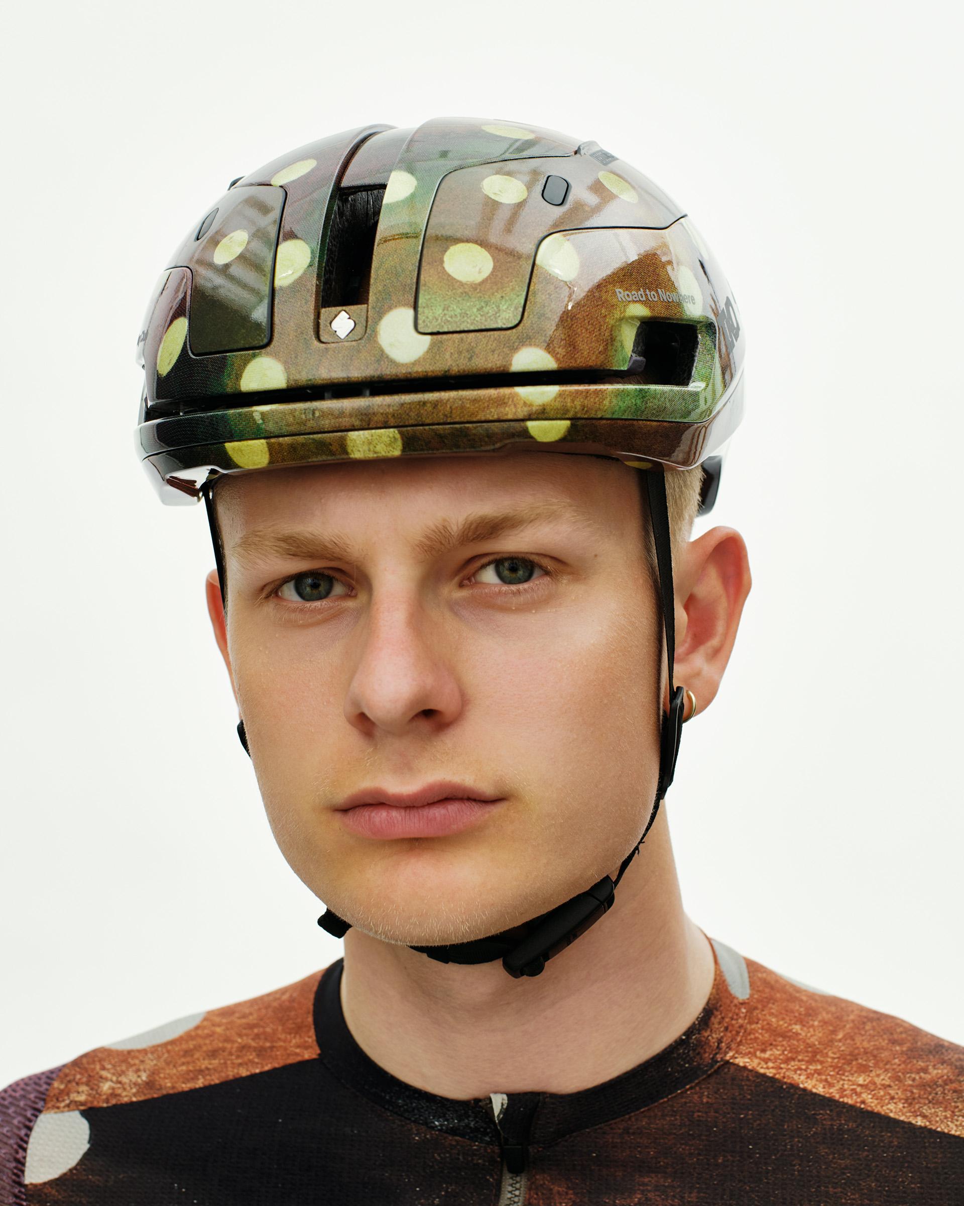 Brown T.K.O. Falconer Aero 2Vi cycling helmet on model with camouflage pattern and yellow dots