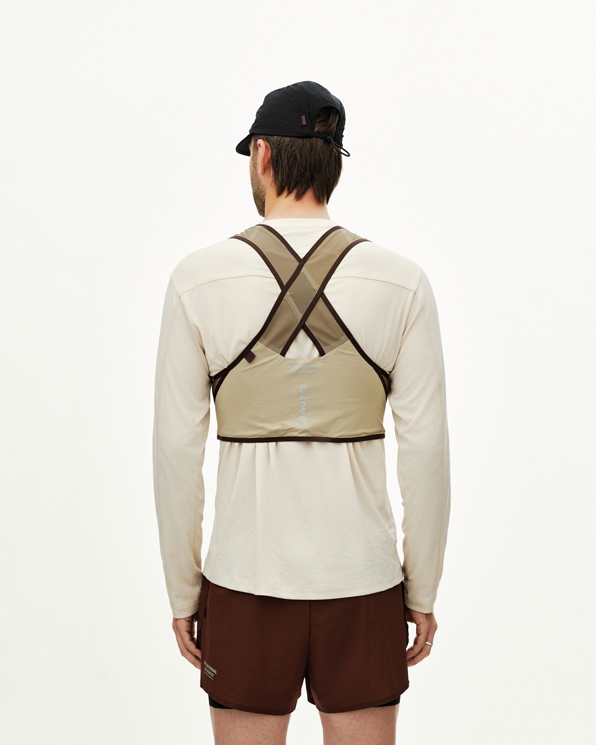 Light Brown Salomon Gravel Concept Skin 2 vest on model, rear view with cross-back strap design