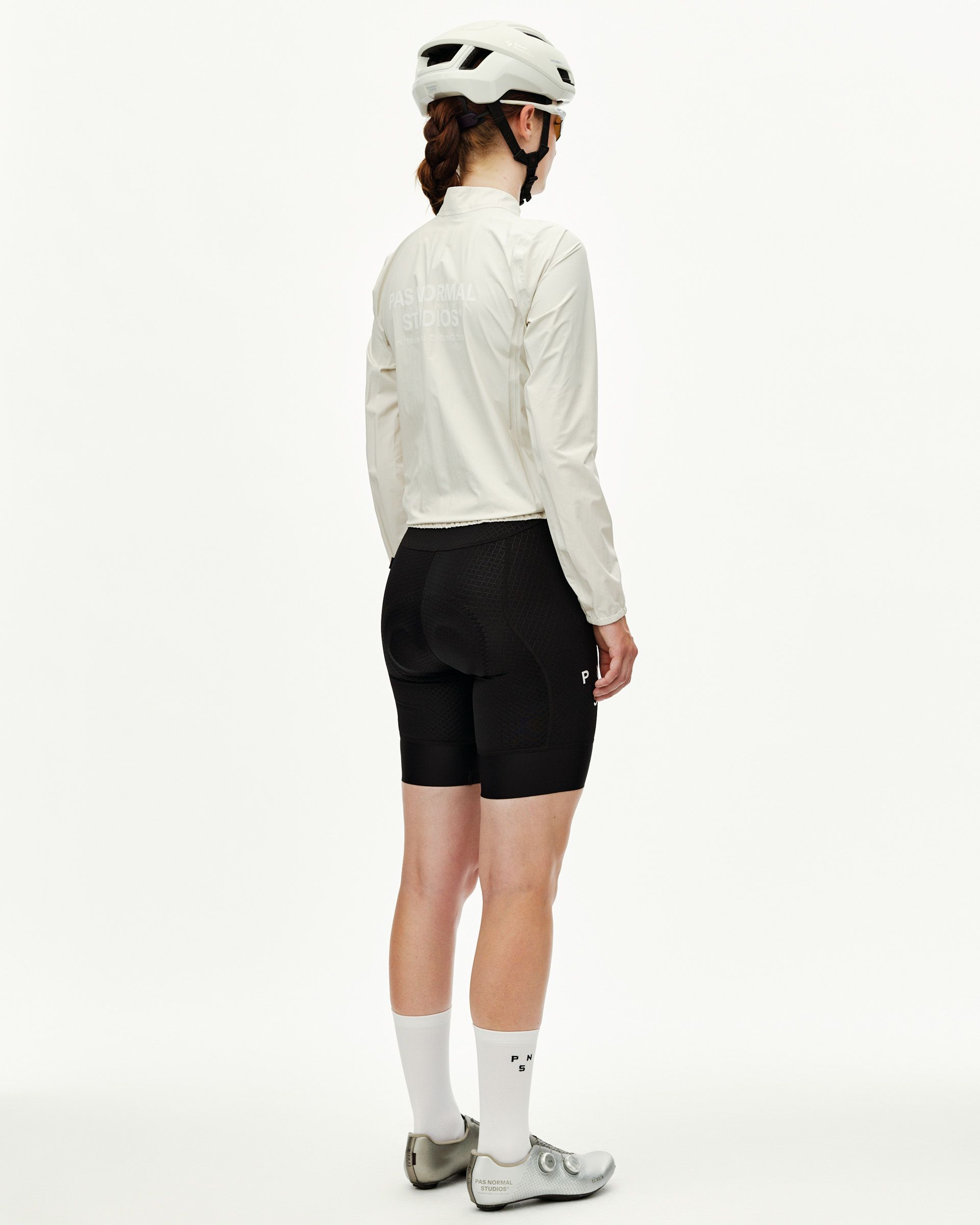 Off White Mechanism women's cycling rain jacket, rear view on model with tonal back logo print