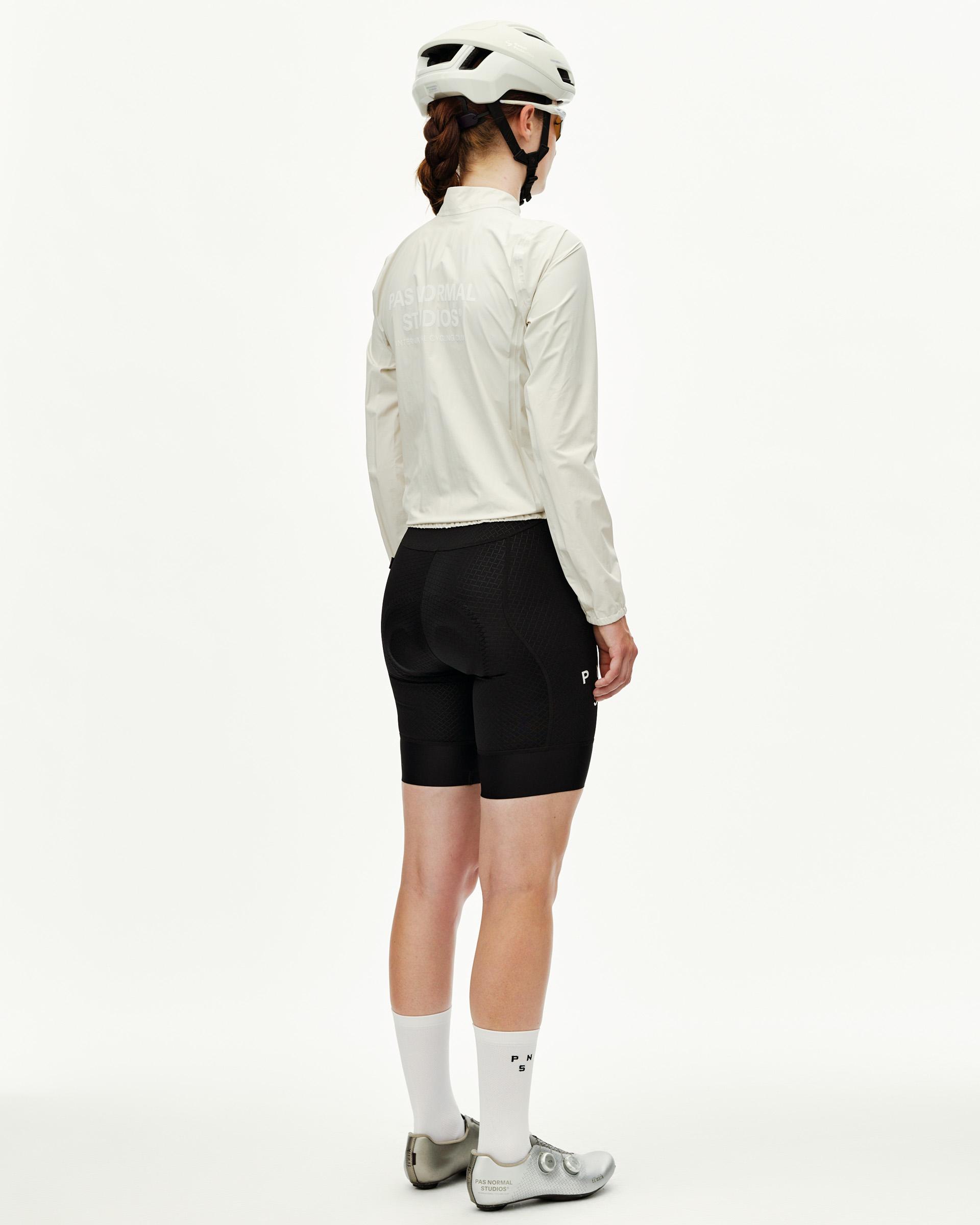 Off White Mechanism women's cycling rain jacket, rear view on model with tonal back logo print