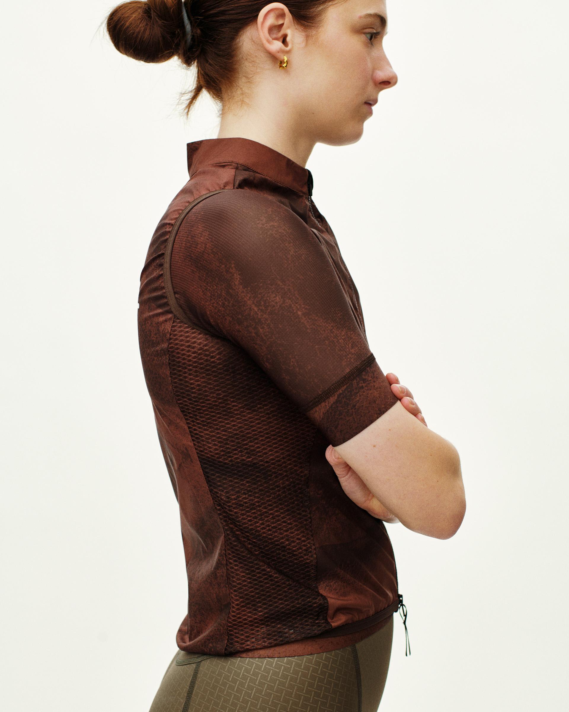 Brown Mechanism Stow Away gilet on model, side view with mesh panels