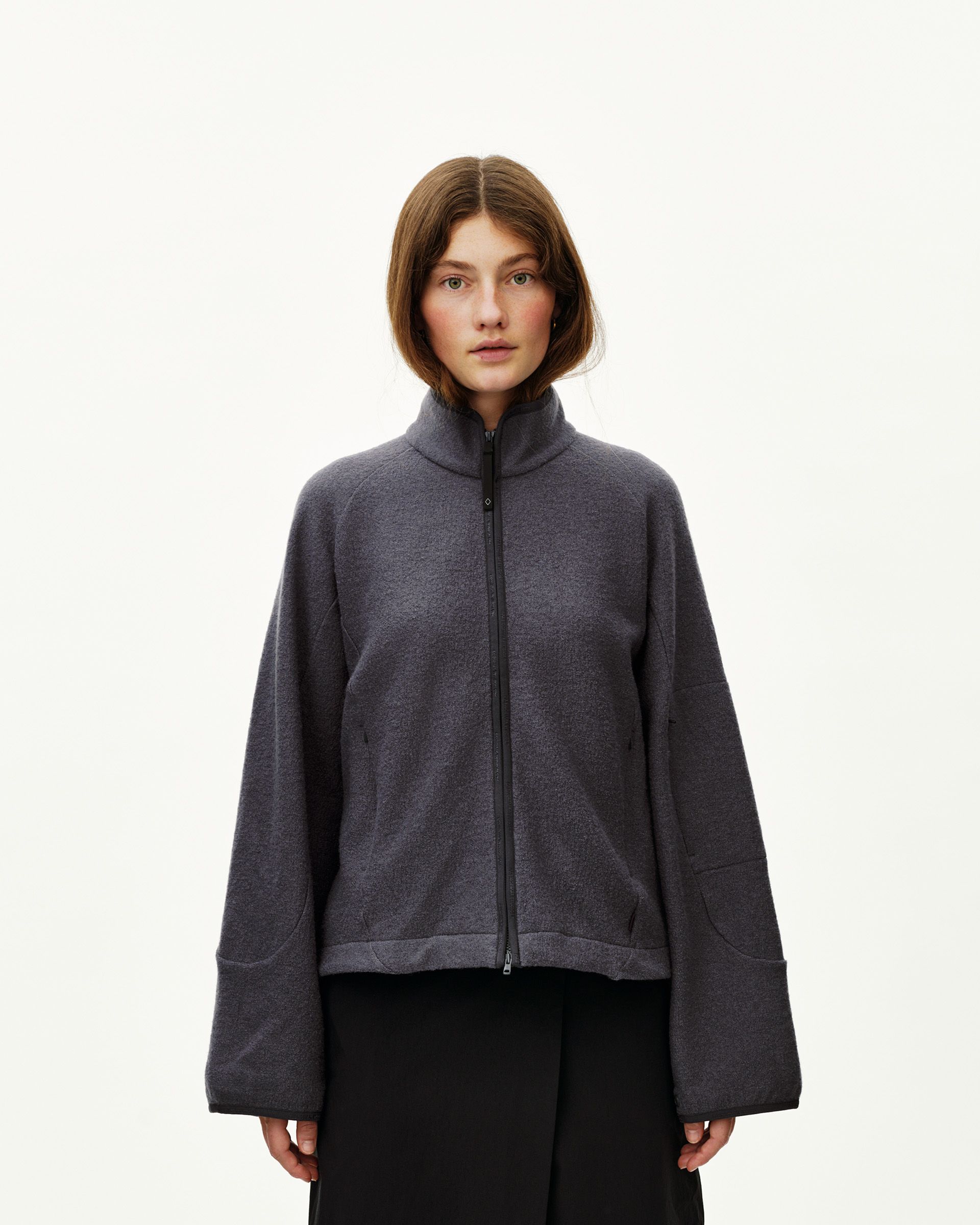 Steel grey Off-Race Boiled Wool jacket on model, front view with full zip and mock neck