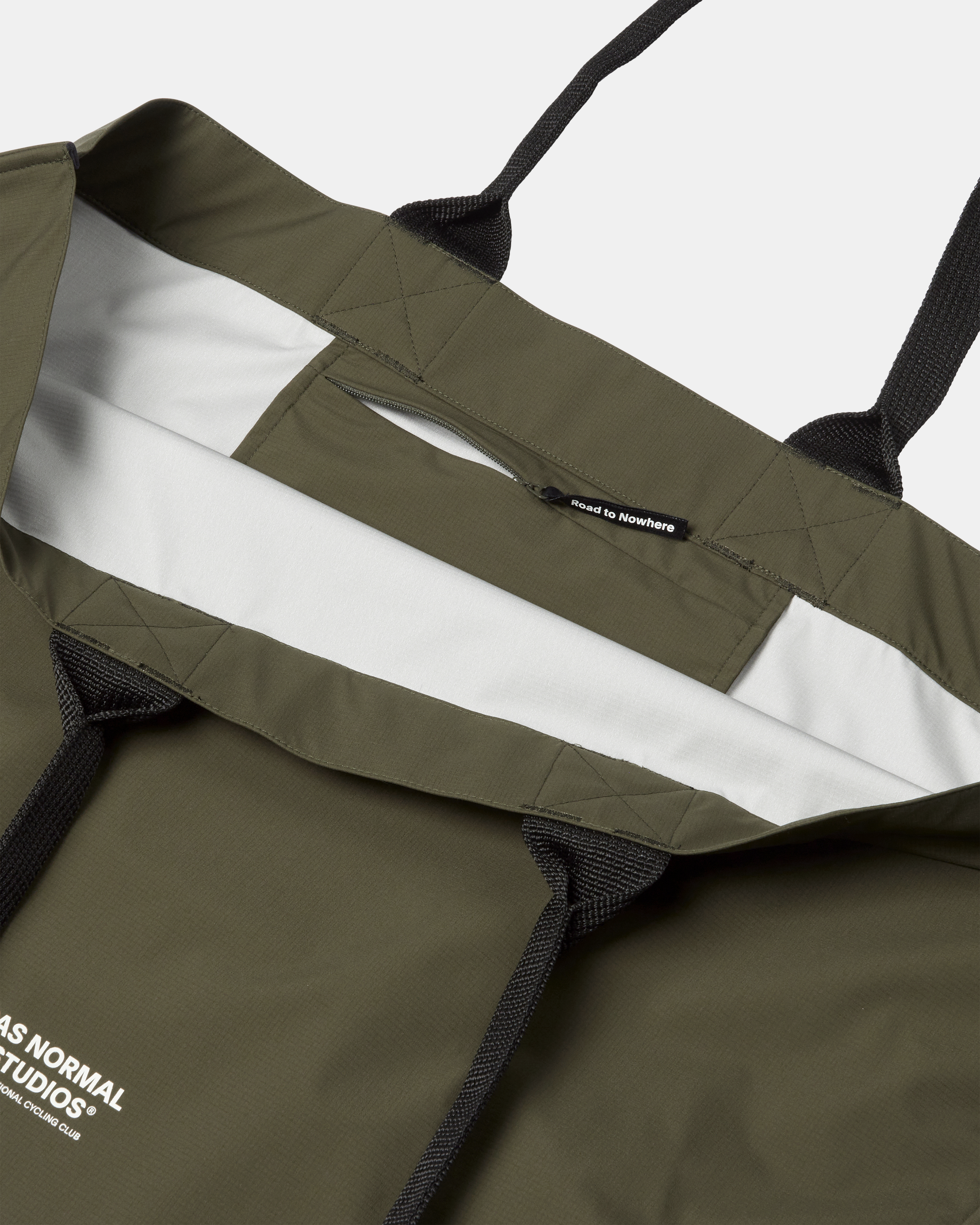 Olive Logo Shield tote bag, opened flat showing white branded liner and zip pocket