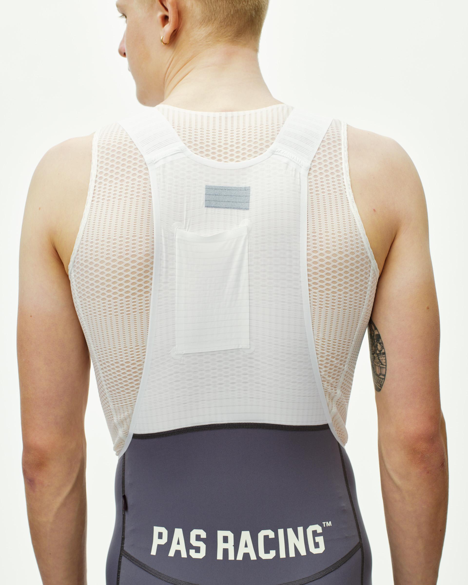 Grey Mechanism Pro PAS Racing cycling bibs on model, rear view with branded waistband